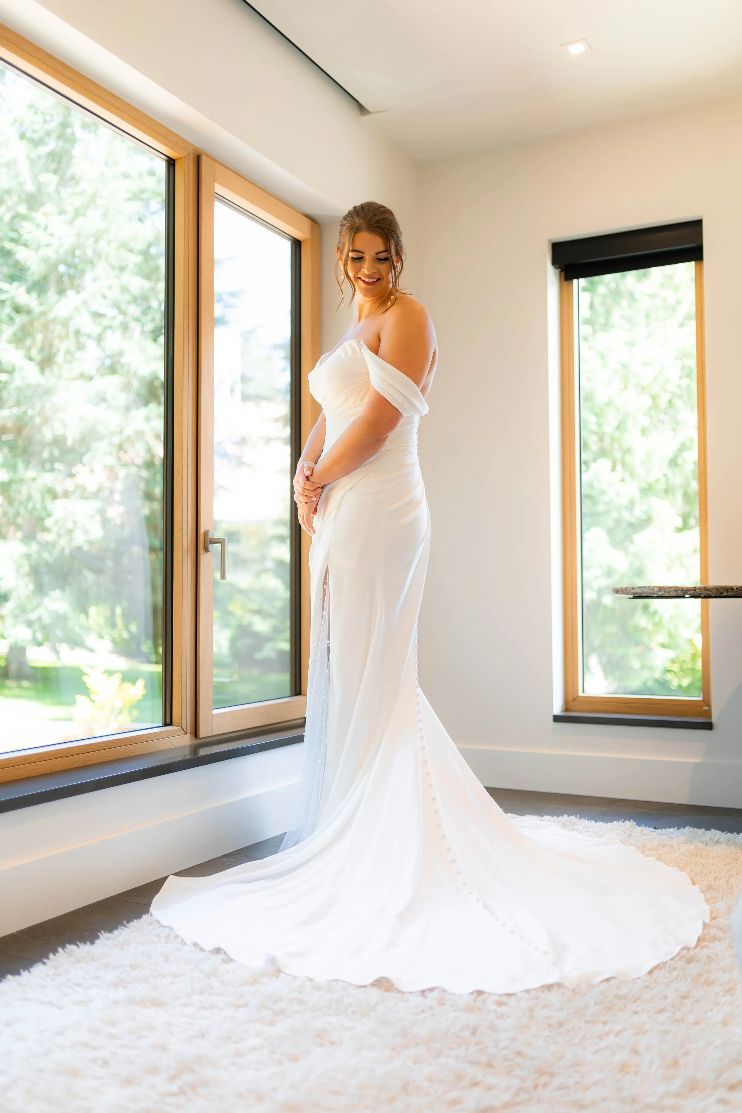 Bride in her wedding gown smiling right before her first look with her soon to be husband, wedding photography by LaFleur Photography.