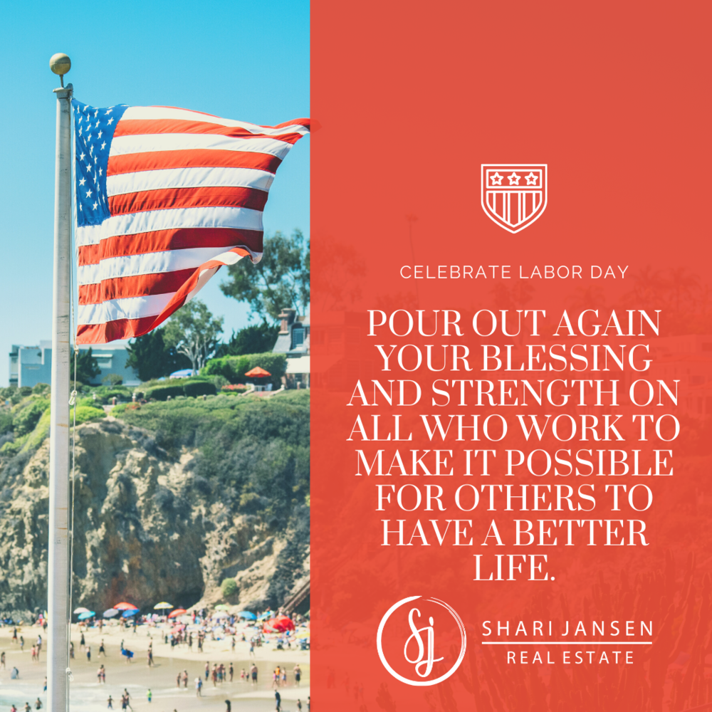 An American flag flying at the beach with cliffs and colorful umbrellas in the background, alongside a Labor Day message from a real estate company.