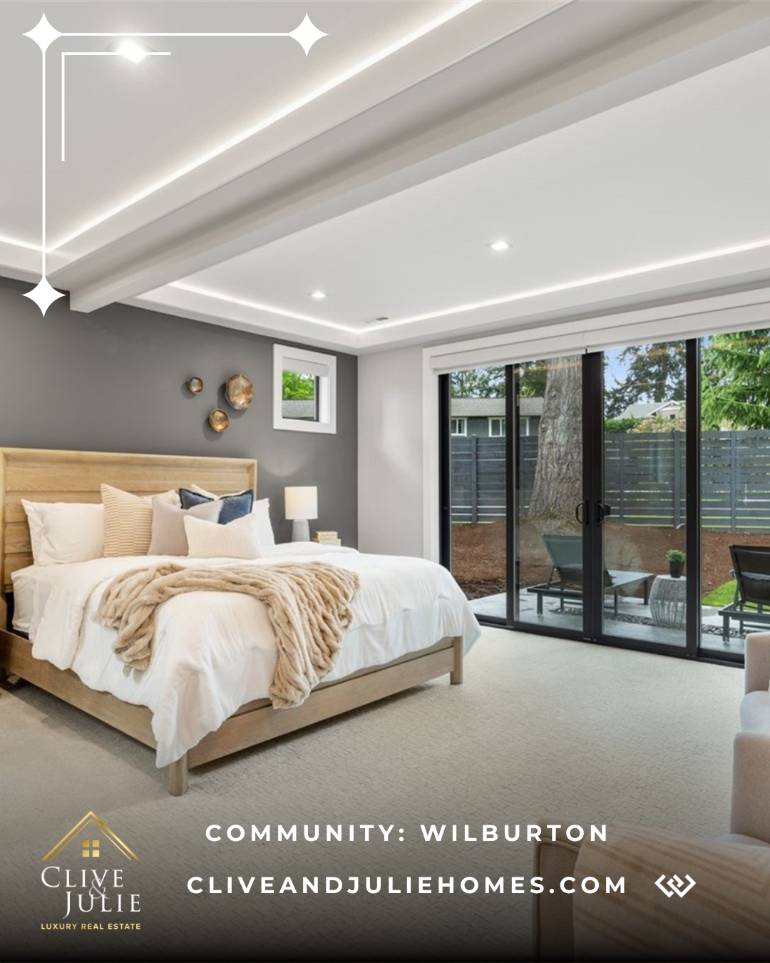 Modern bedroom with a wooden bed, cozy blankets, and natural light from sliding glass doors leading to a backyard patio.