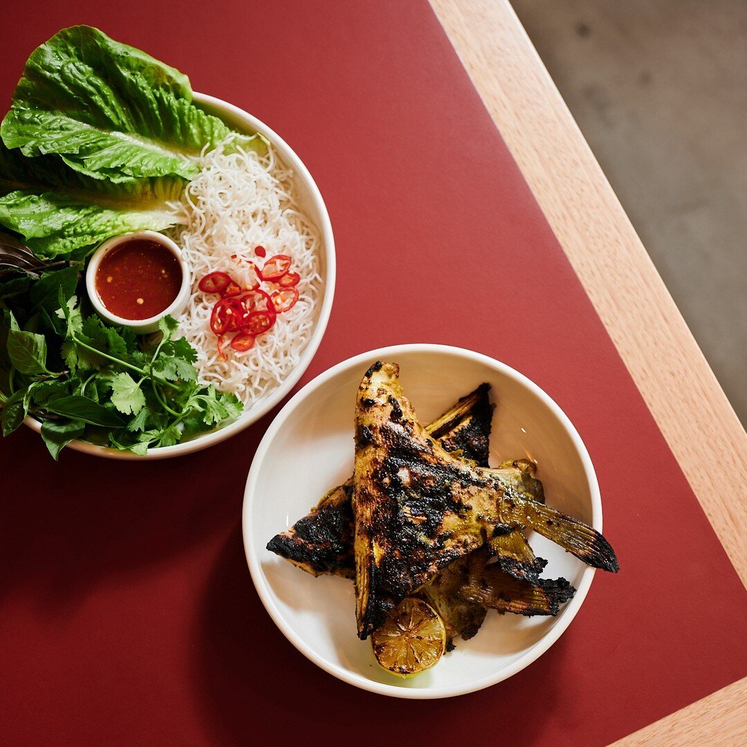 CA NUONG​​​​​​​​
​​​​​​​​
Barbecued barramundi collars marinated with dill and turmeric, served with noodles, lettuce wraps and fresh herbs.​​​​​​​​
​​​​​​​​
One of our customers' favourite dishes.  Eating with hands completely recommended.  Pairs pe