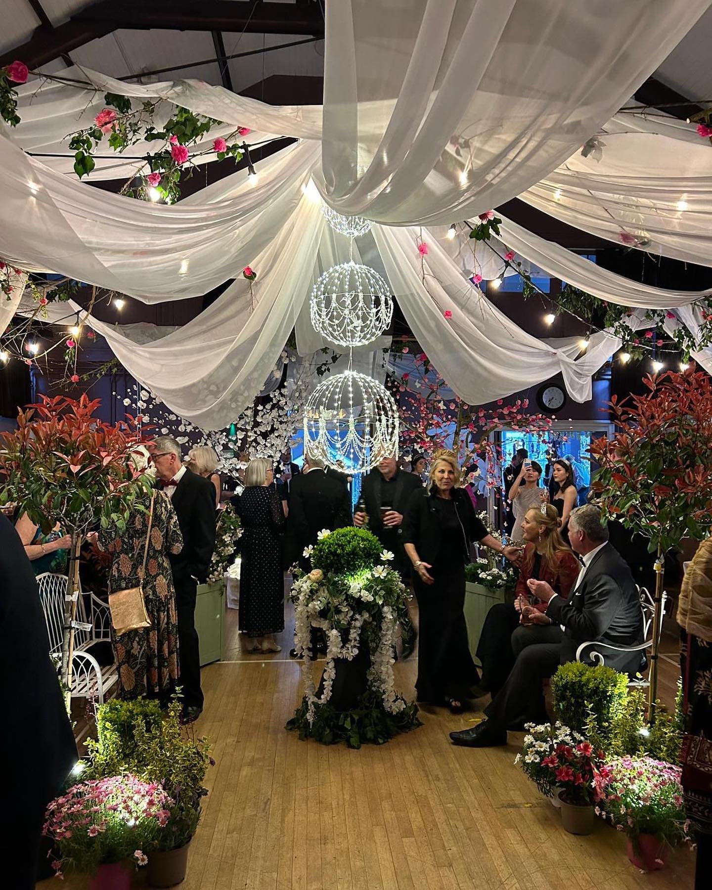Guests admiring the QVH transformation 

#oundlecharityball #springball #blacktie #oundle #communityevents #loveoundle #swingband #dancing #enchantedgarden