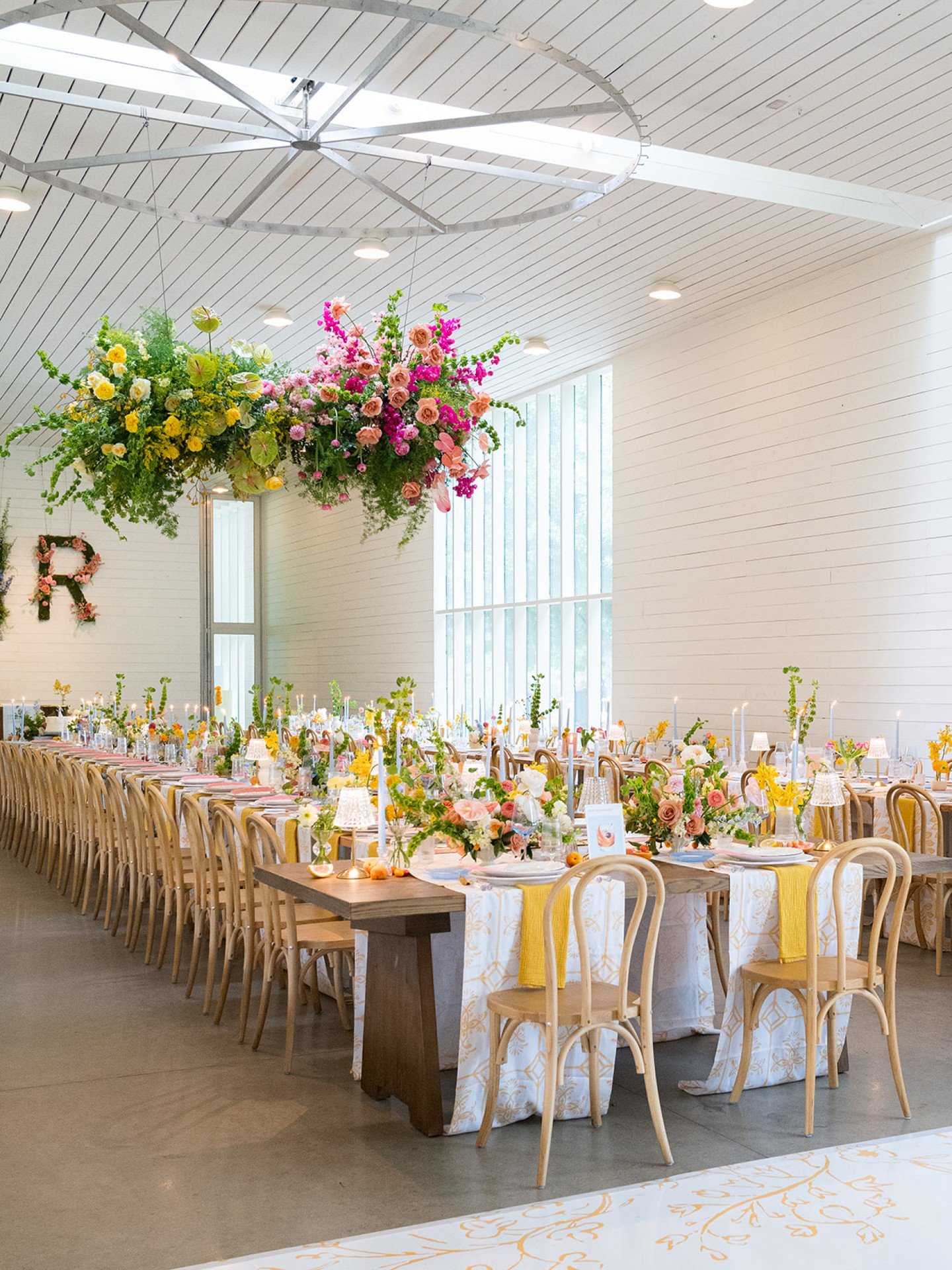 A maximalist floral moment complete with fruit-flecked tables, citrus cocktails, and old fashioneds with their own monogrammed ice cubes (because&hellip; obviously).

Pinks, blues, and yellows showed up in their summer best, and our Aggie couple brou