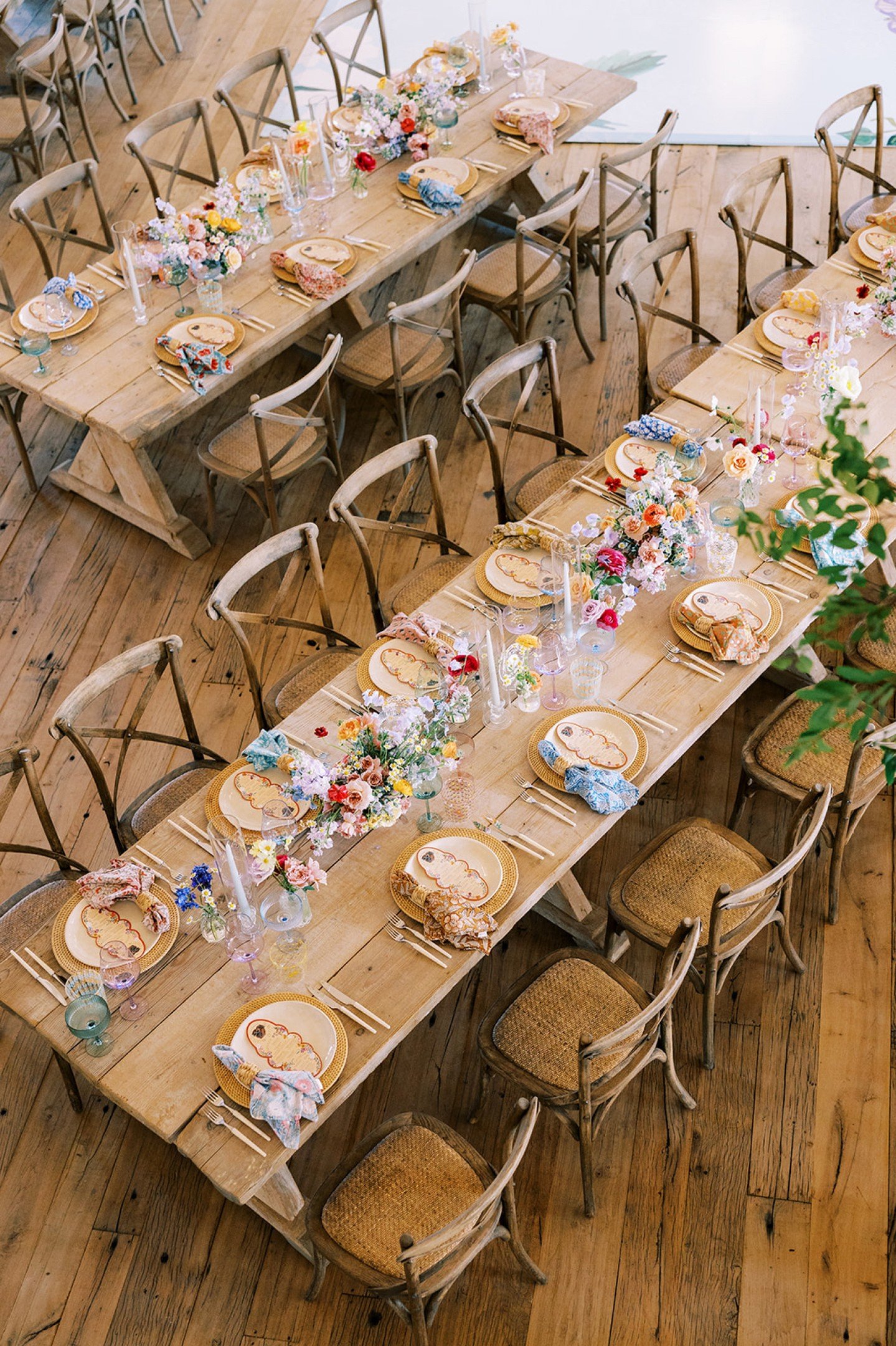 From the moment guests stepped onto the property, it felt like walking into a painting: vibrant wildflowers spilling down long French farm tables, layered with mismatched glassware &amp; vivid spring hues. The kind of tablescape that makes you want t