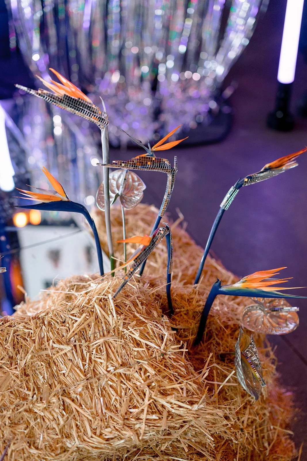 Detail view of floral details in front of the speaker stage for a rodeo-disco themed corporate event in houston texas