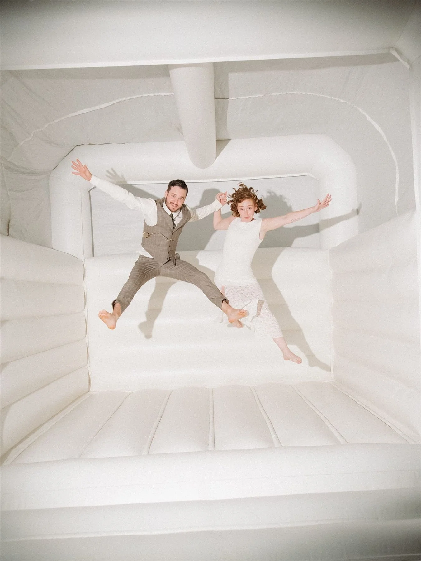 gen z wedding humor during bride and groom bounce house moment