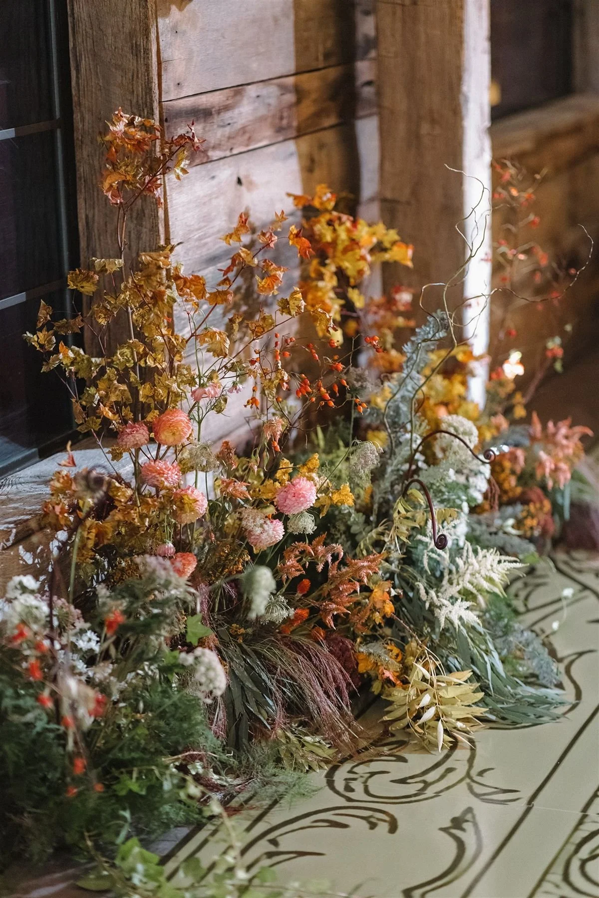 Wild, organic, fall wedding florals at the edge of the dance floor on green vinyl wrapped dance floor - houston wedding planners epoch co+