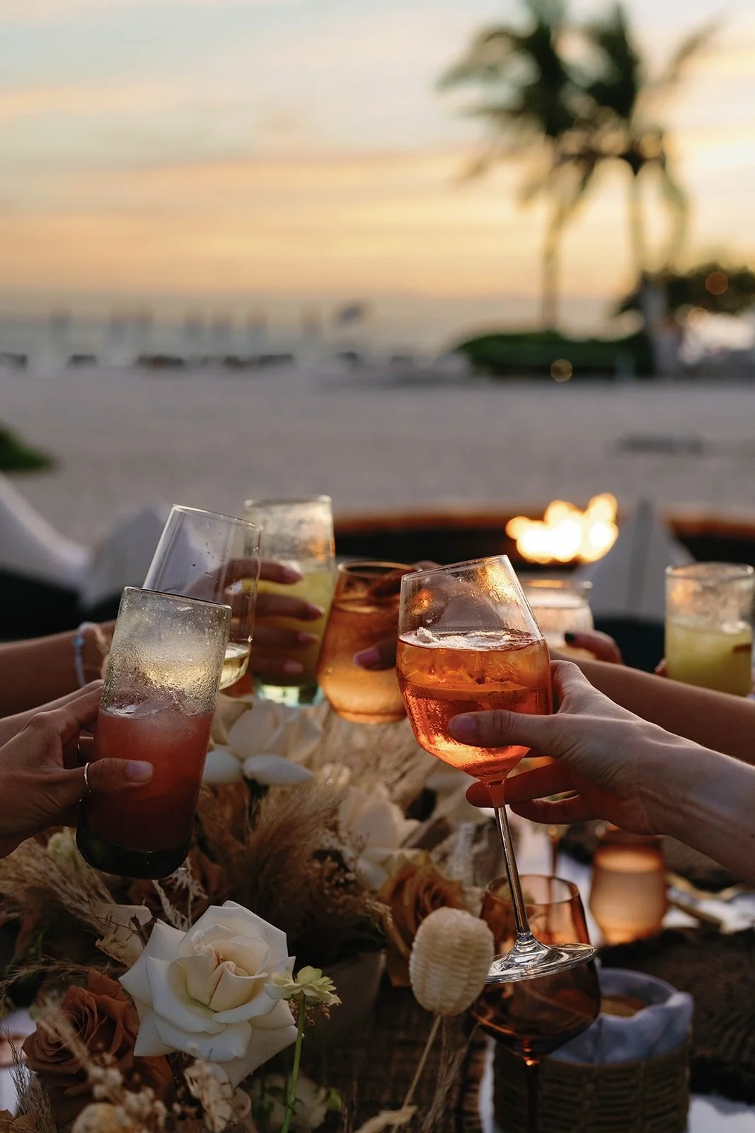 Guests cheering cocktails on Mexico beach during corporate retreat