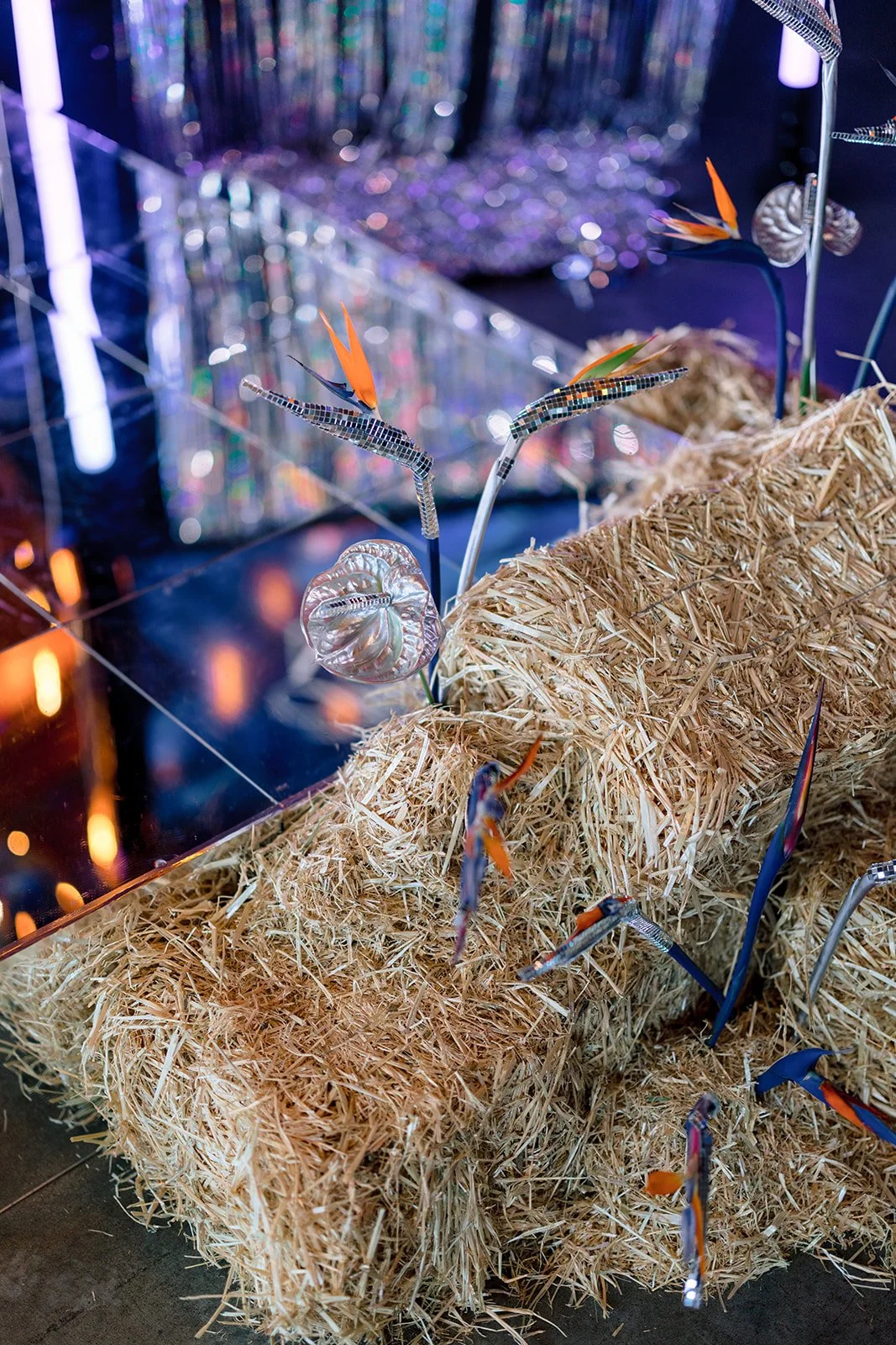 Houston rodeo and disco speaker stage with hay bales and disco tropical flowers by houston wedding planners near me epoch co