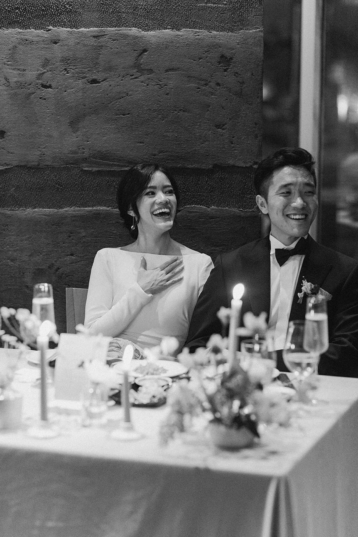 asian wedding couple black and white image during toasts at restaurant wedding in houston texas