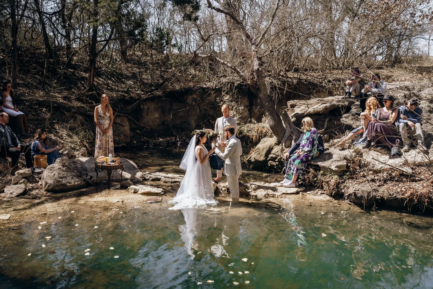Bride and groom stand in water for Texas wedding ceremony