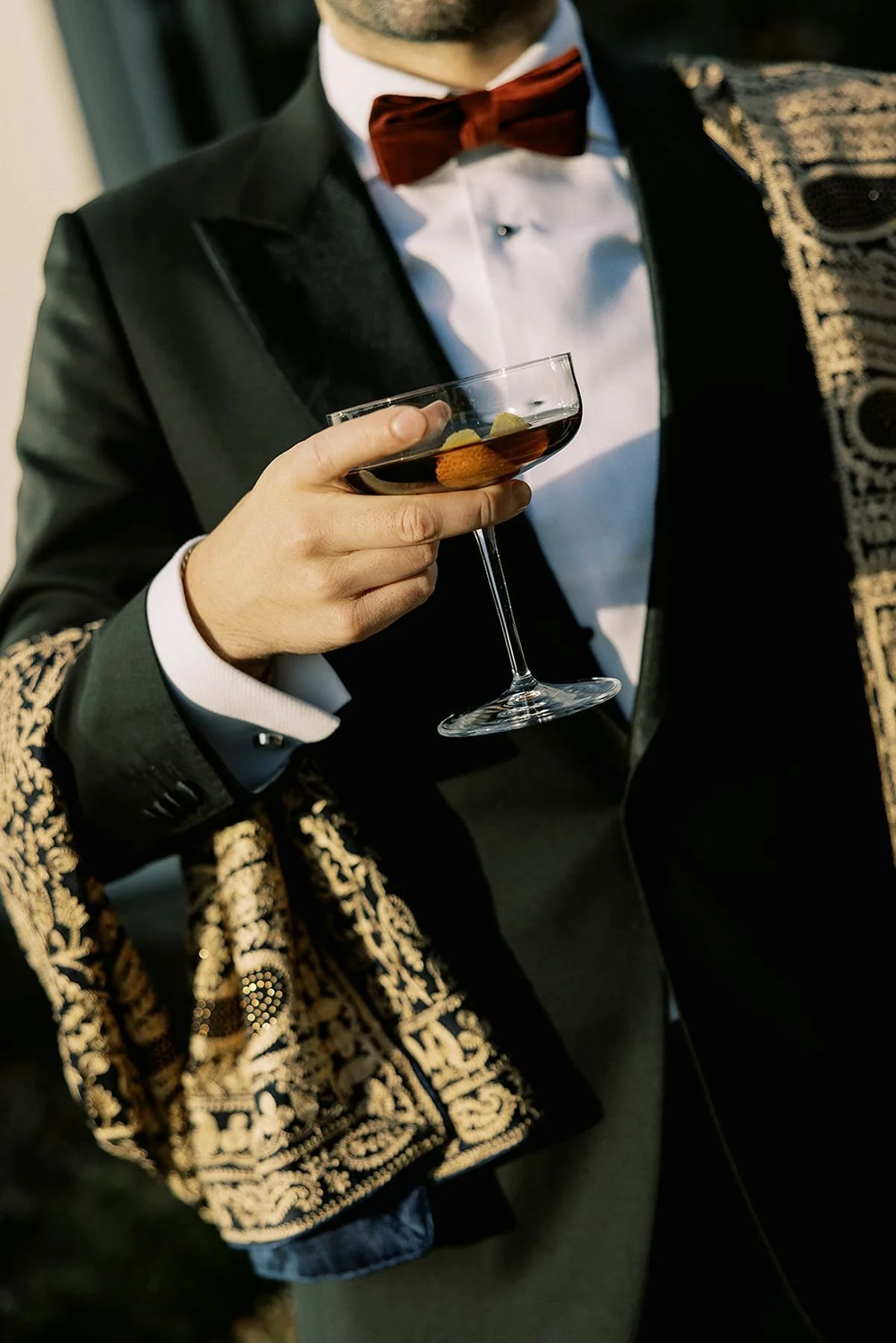 Groom at Hindu wedding holding an old fashion on a coupe