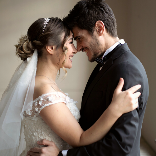 Bride and groom embracing on wedding day