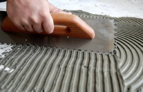 RemodelThisHouse-InstallingCeramicTile-Thinset-Mortar-Trowel.jpeg