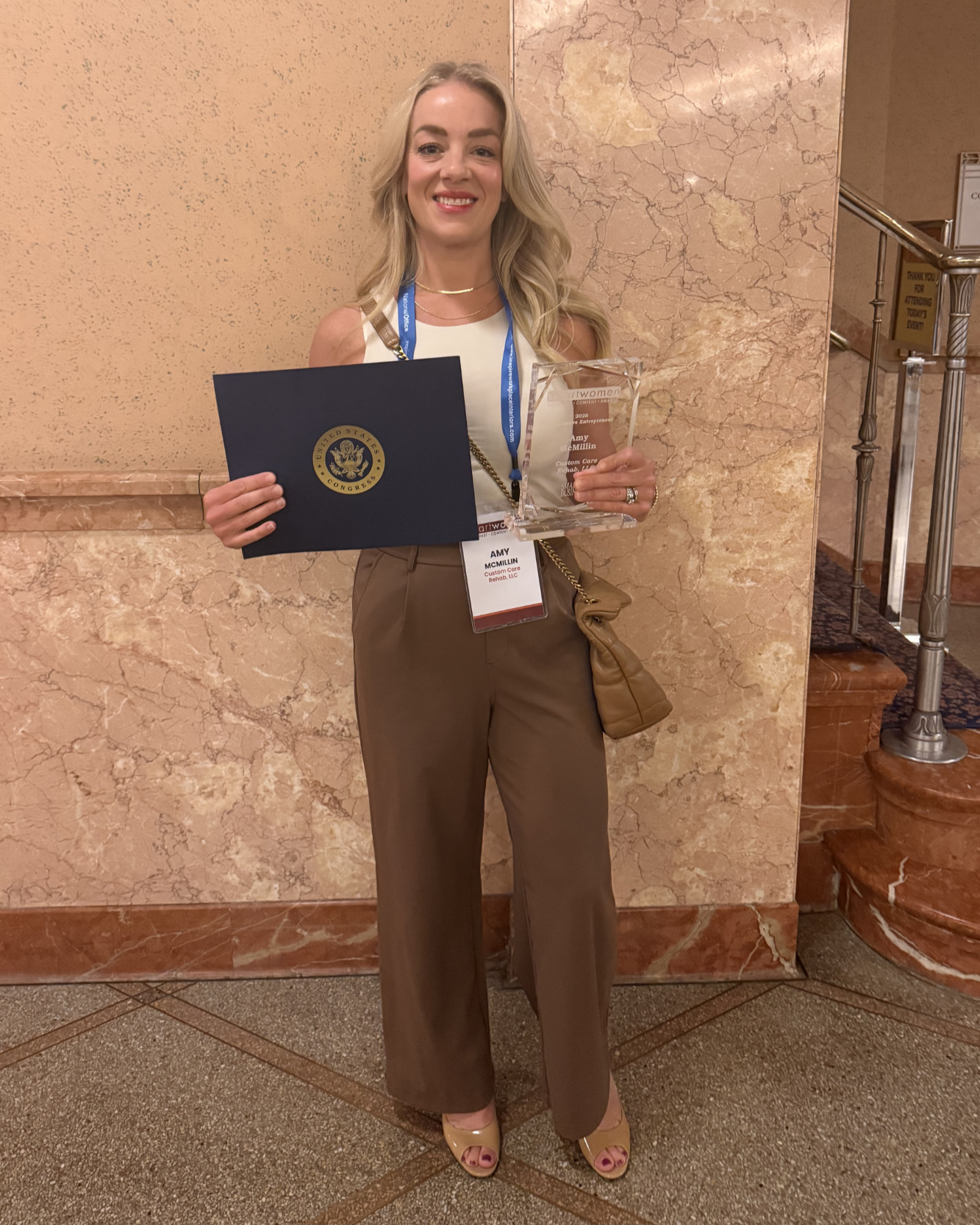 blonde woman holding award