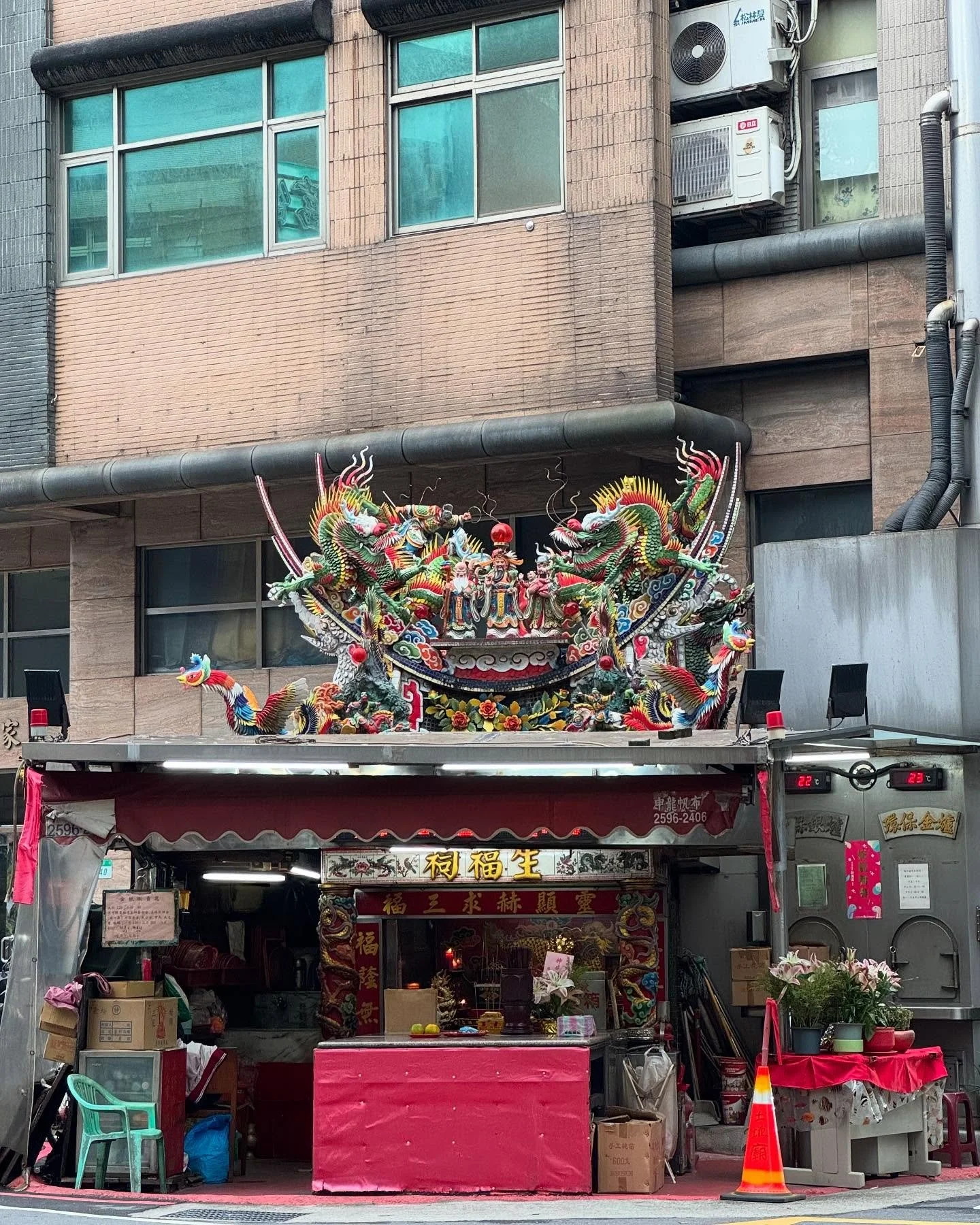 Taipei. A tiny temple at the foot of a building.