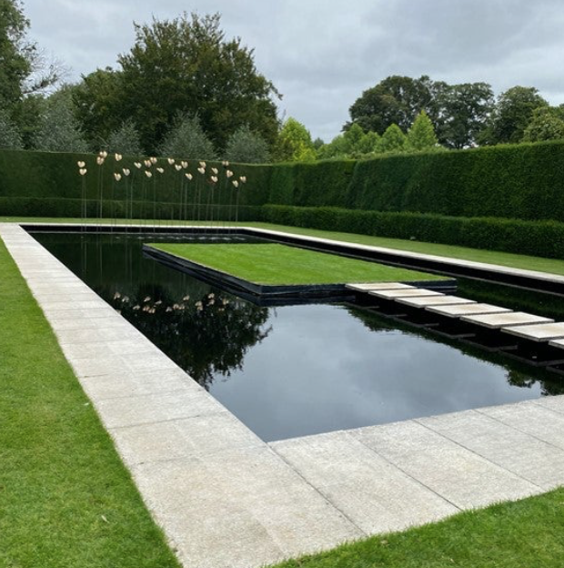 The elegant new pond garden replaced an old tennis court.