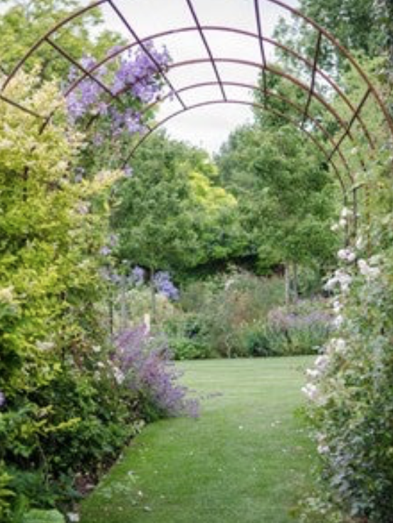 A tunnel elegantly divides one area of the garden from another.