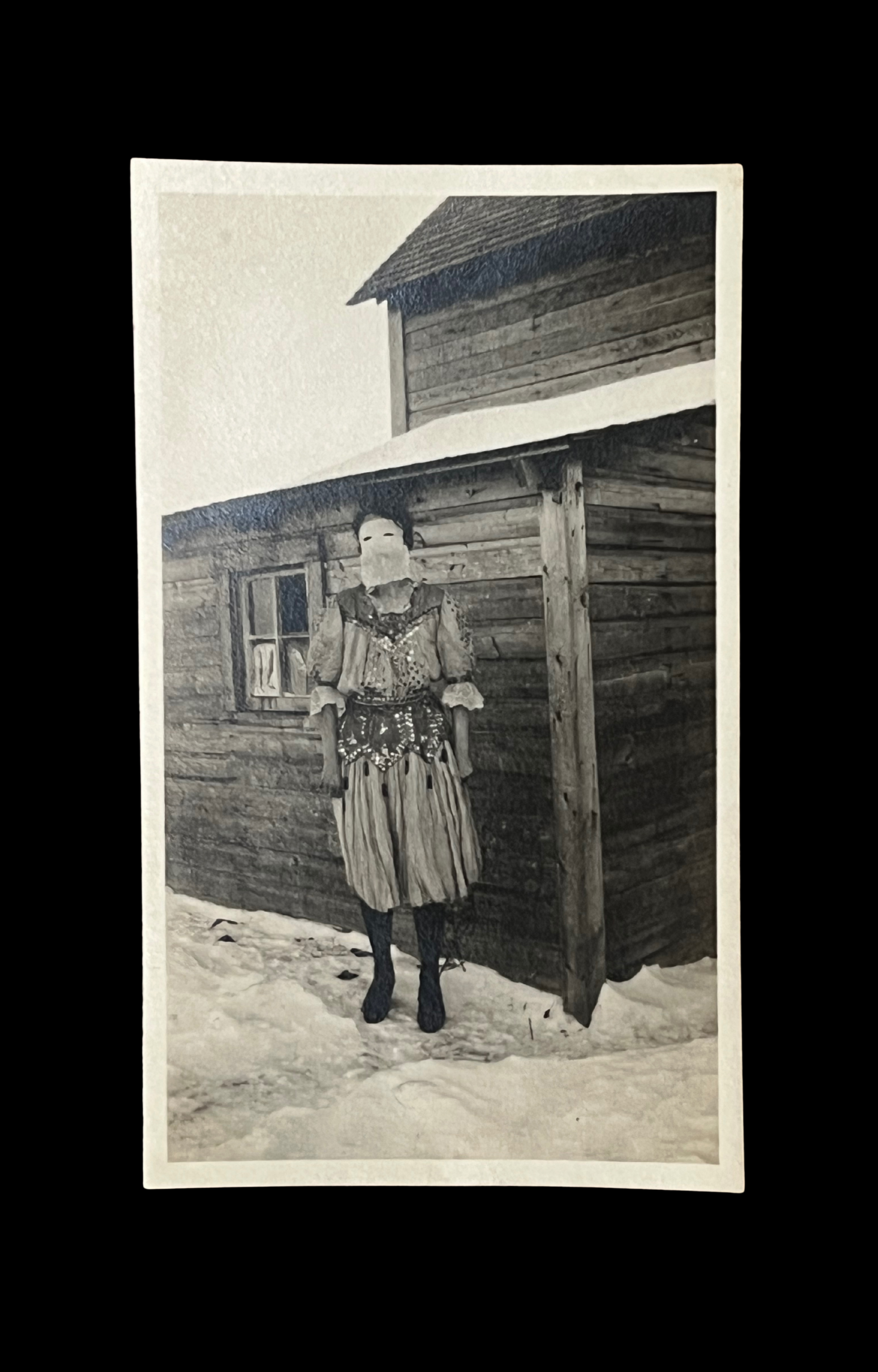 Masked Costumed Figure Outside of Snowy Cabin, Snapshot, c. 1920’s