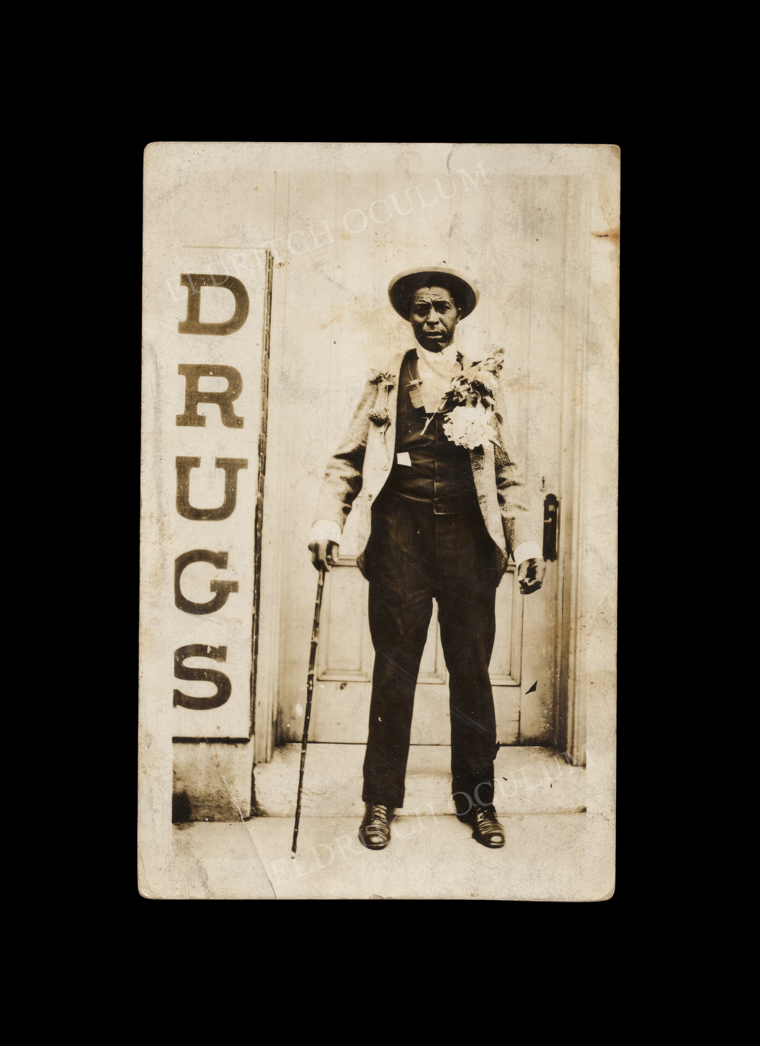 Distinguished Gentleman Adorned with Large Flowering Plants, real-photo postcard, c. 1908