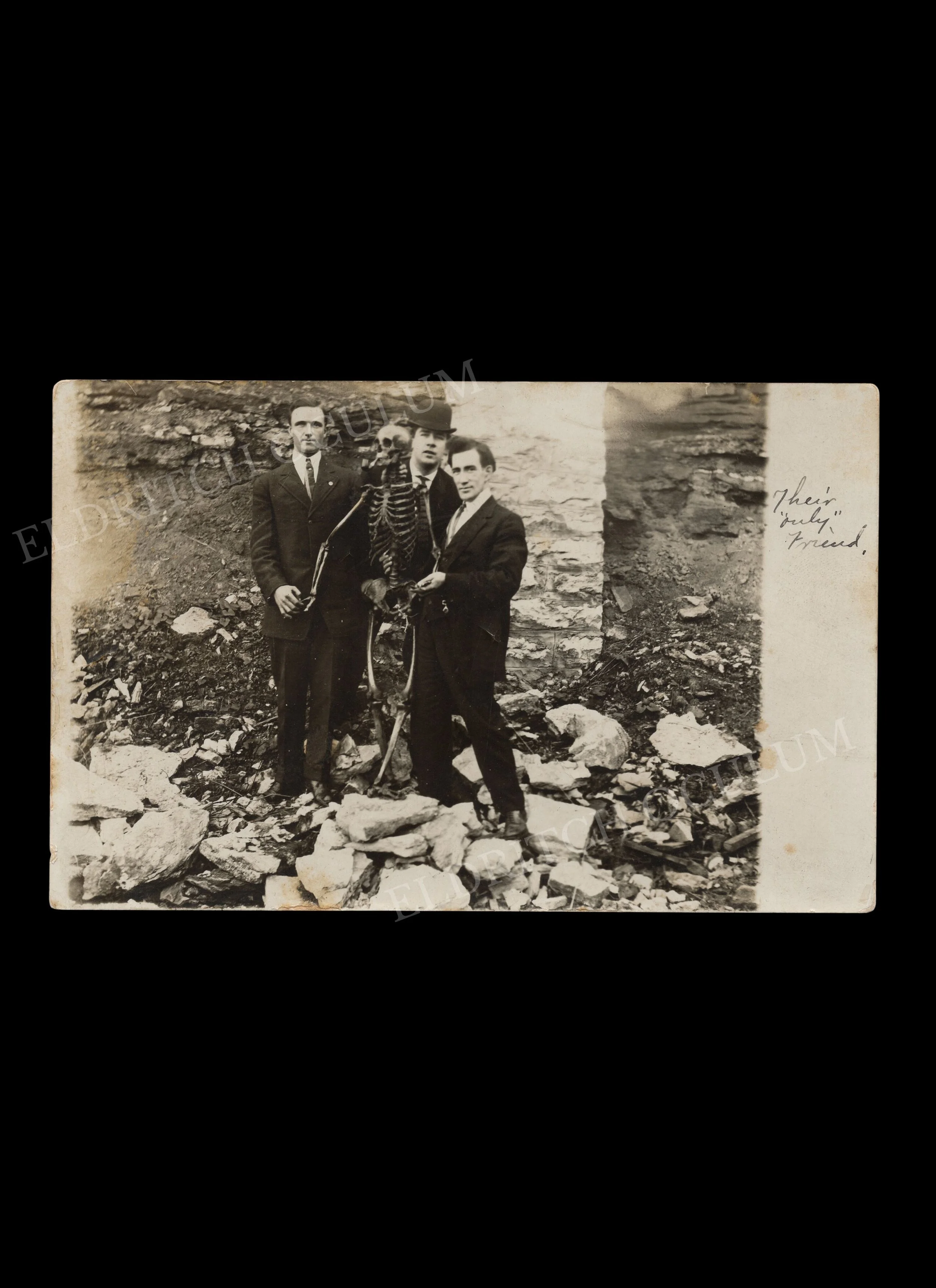 "Their Only Friend", Three Men Holding Human Skeleton Among Rubble, real-photo postcard with title in ink, c. 1918