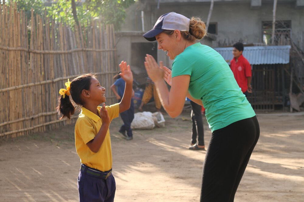 BlinkNow Kopila Valley student playing game with Maggie Doyne
