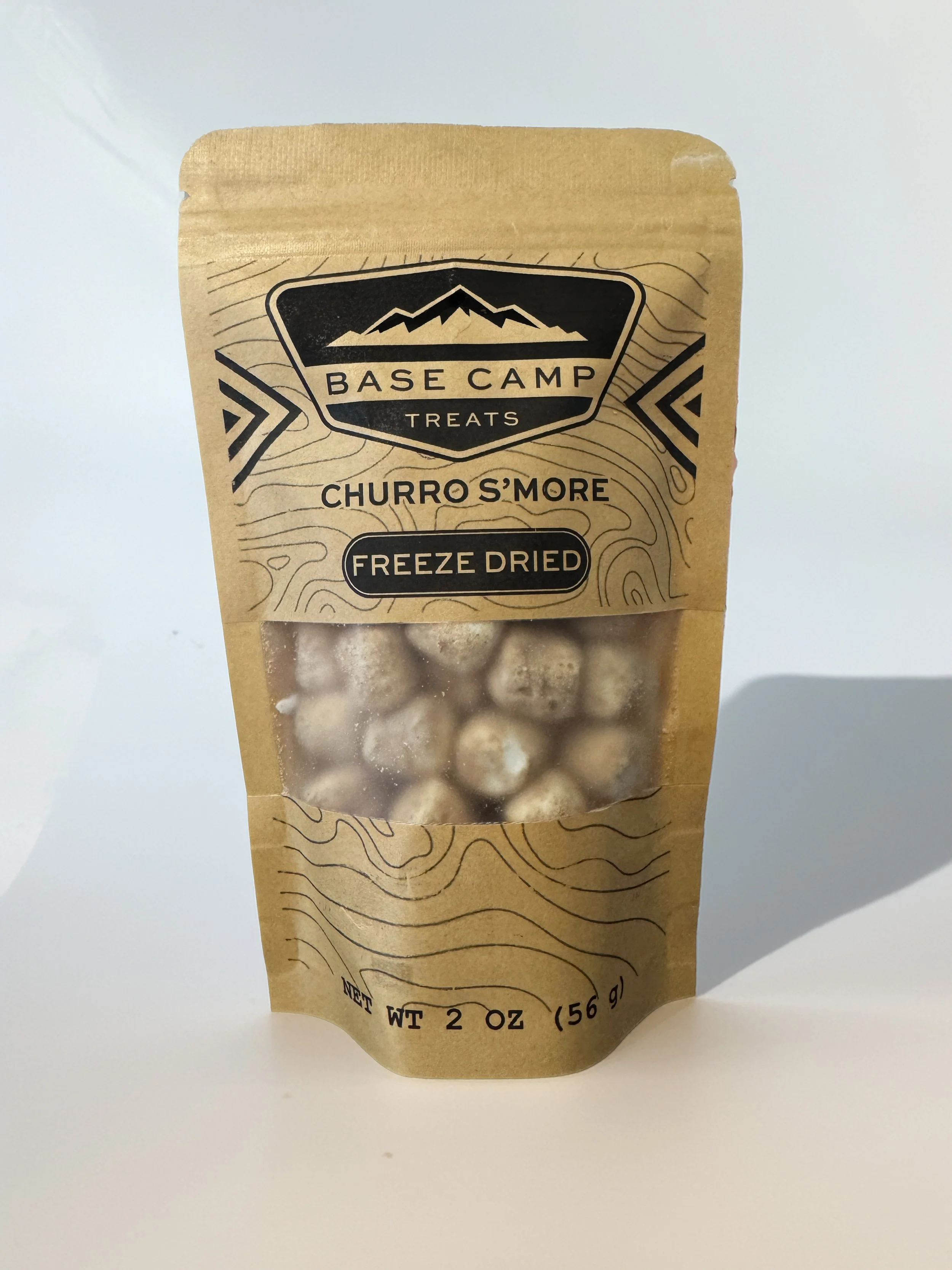 Base Camp Treats Freeze Dried Churro S’mores in kraft stand-up pouch with cinnamon sugar marshmallow pieces visible through clear window