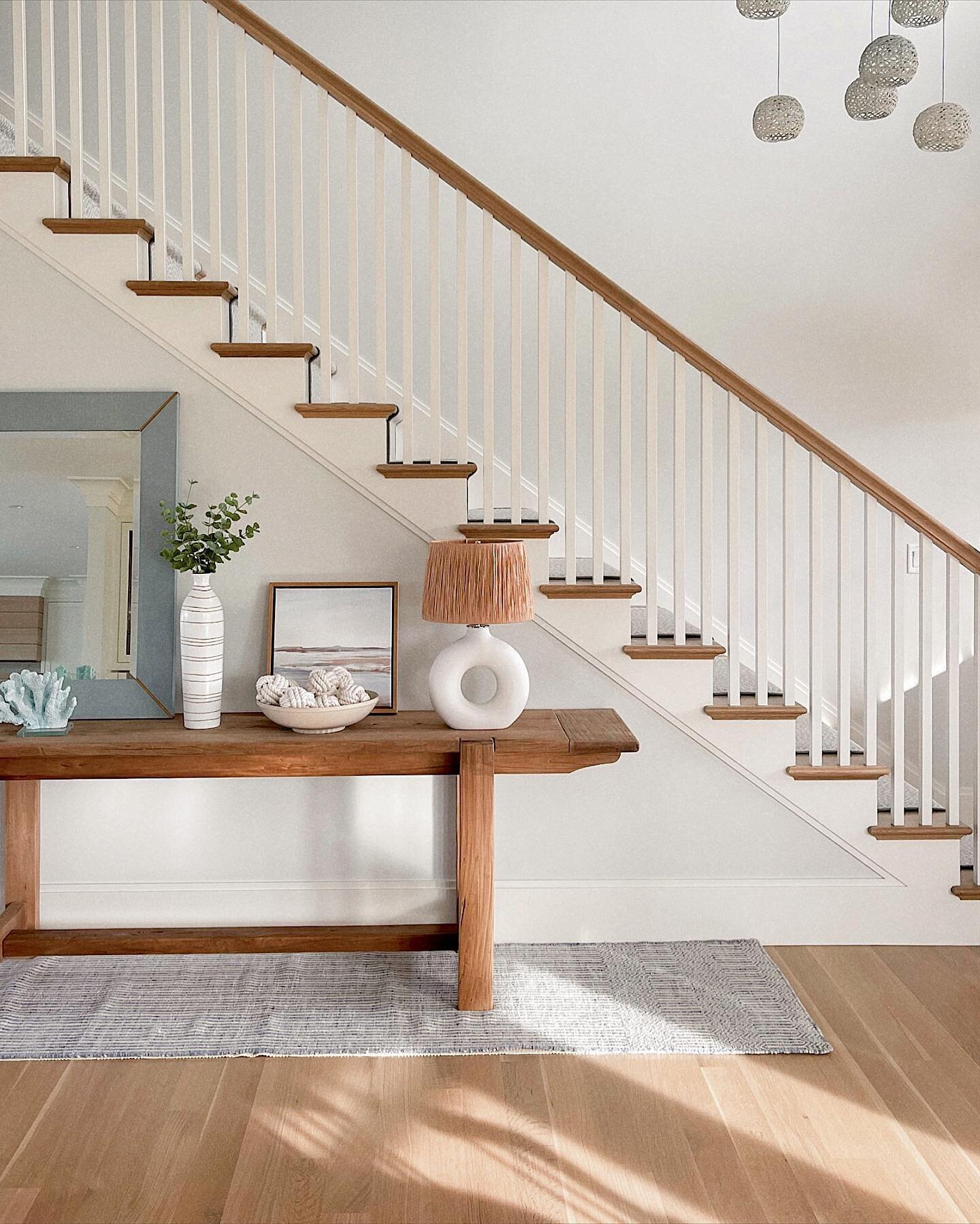 Coastal-traditional stairs with a white oak rail &amp; treads and painted poplar balusters and at the #RiverView project.

Builder: @horanbuilding 

#interiors #interiorarchitecture #interiordesign #naturallight #coastalcottage #cottagedecor #morning