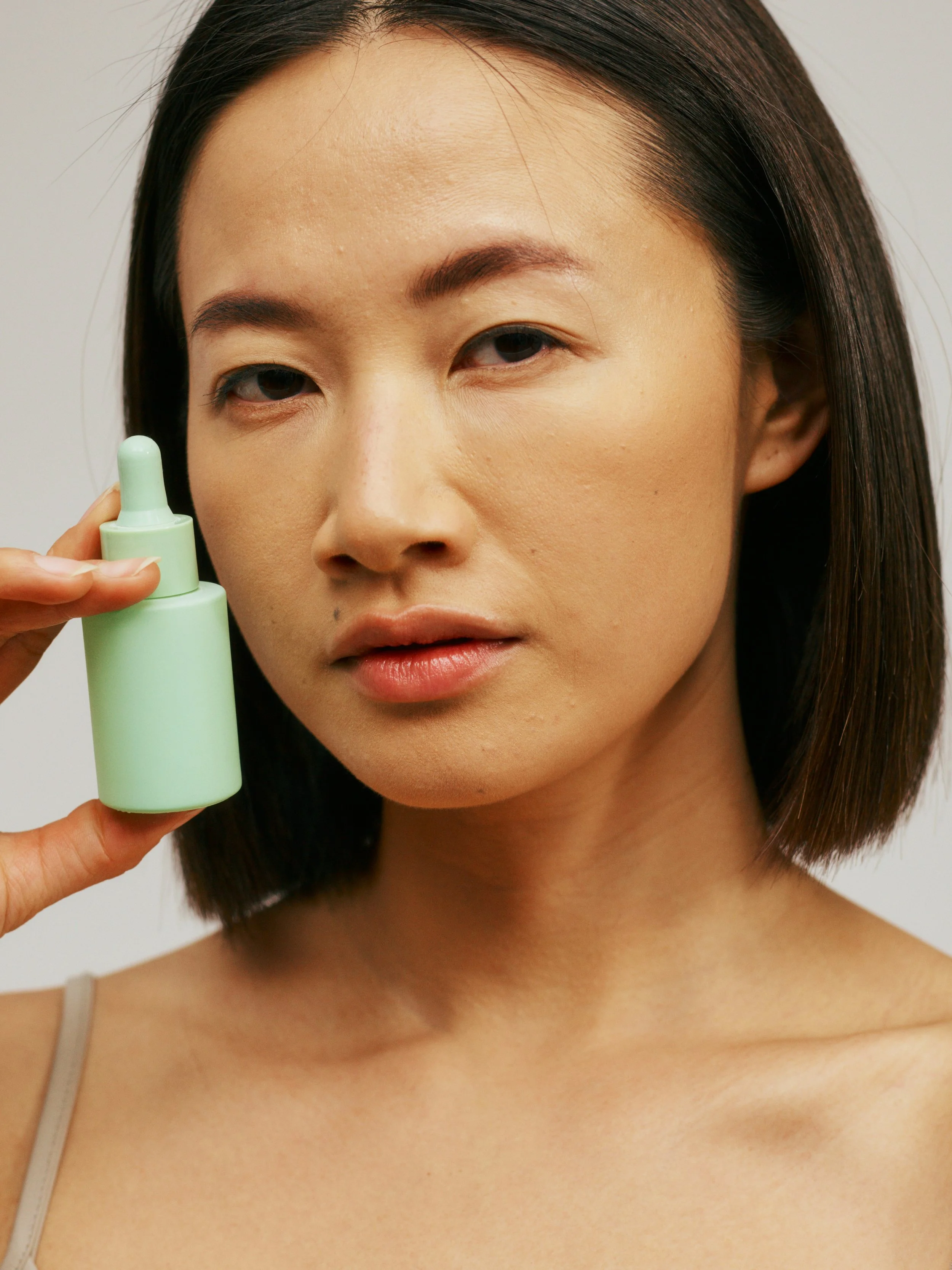 cosmeta woman with green bottle
