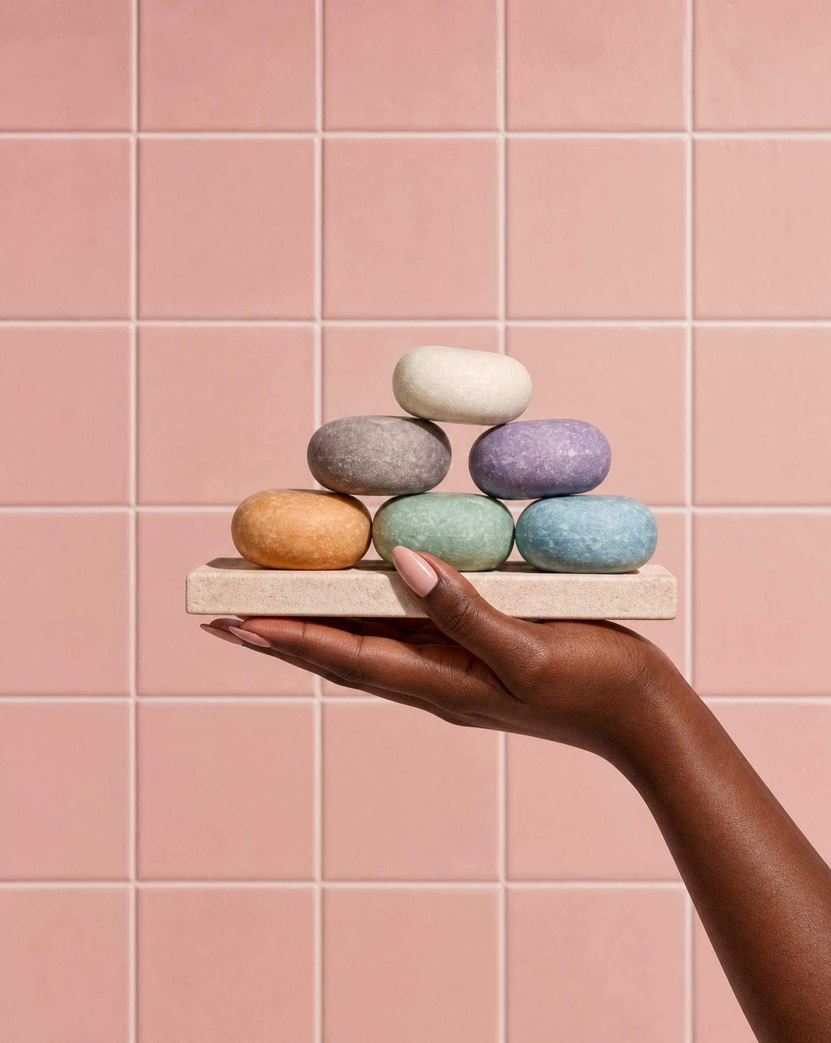 waterlesssoap products on a tray cosmetic chemist holding