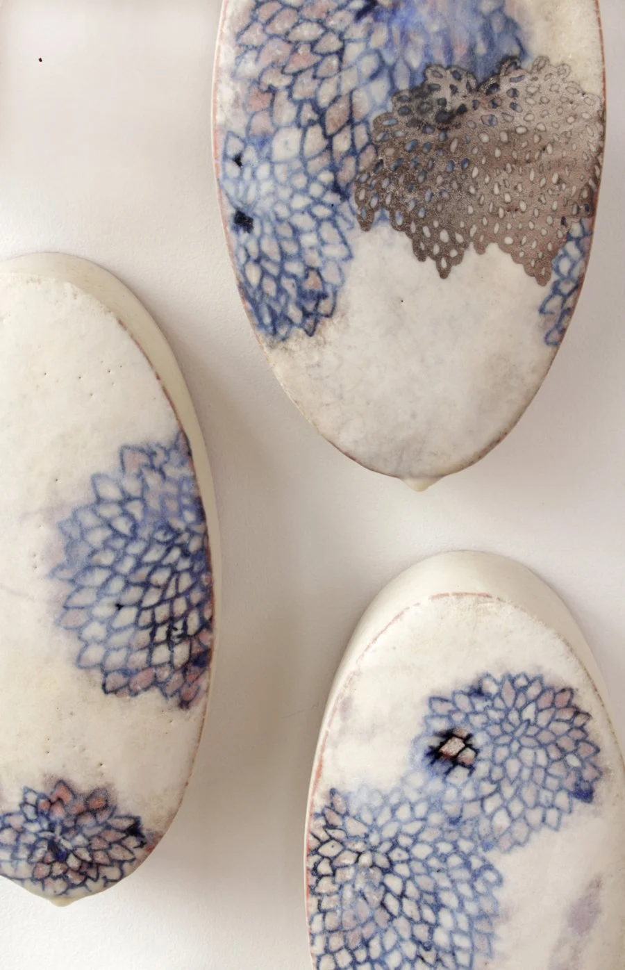   Chrysanthemum Wall , detail Ceramic, glaze and stain inlay, white gold luster, encaustic Dimensions of each element approximately 7” x 4” x 3” 