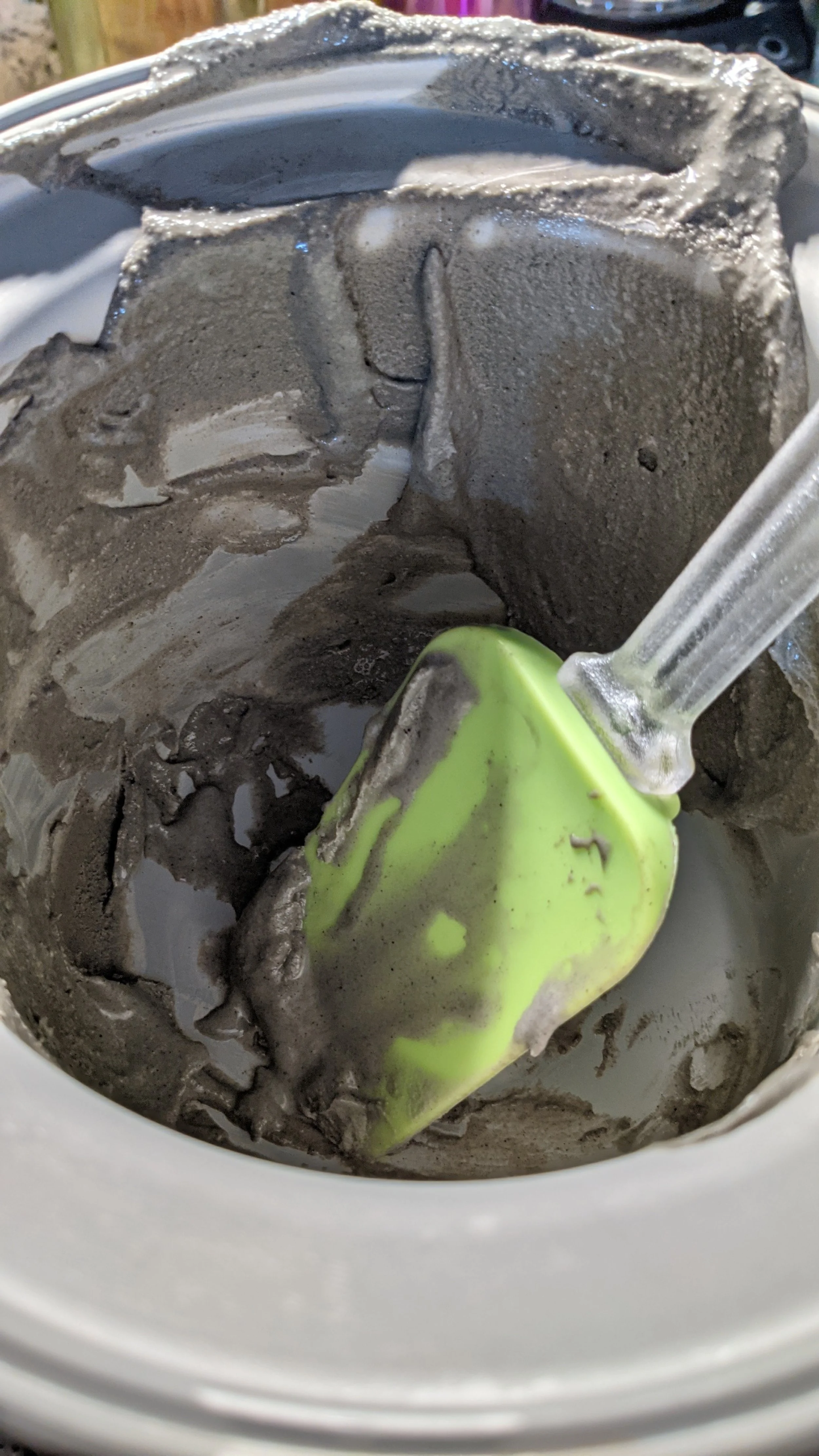empty ice cream maker with remnants of black sesame ice cream