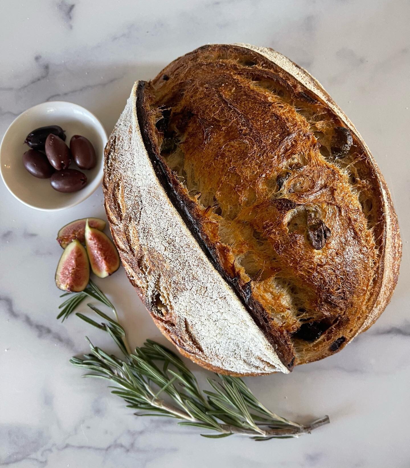 Fig &amp; Olive Sourdough.  Made with organic Artisan Bakers Craft bread flour, organic hard white wheat and freshly milled organic Red Fife.  Gently folded in dried Mission Figs, Castelvetrano green olives and Kalamata olives.  Naturally leavened wi