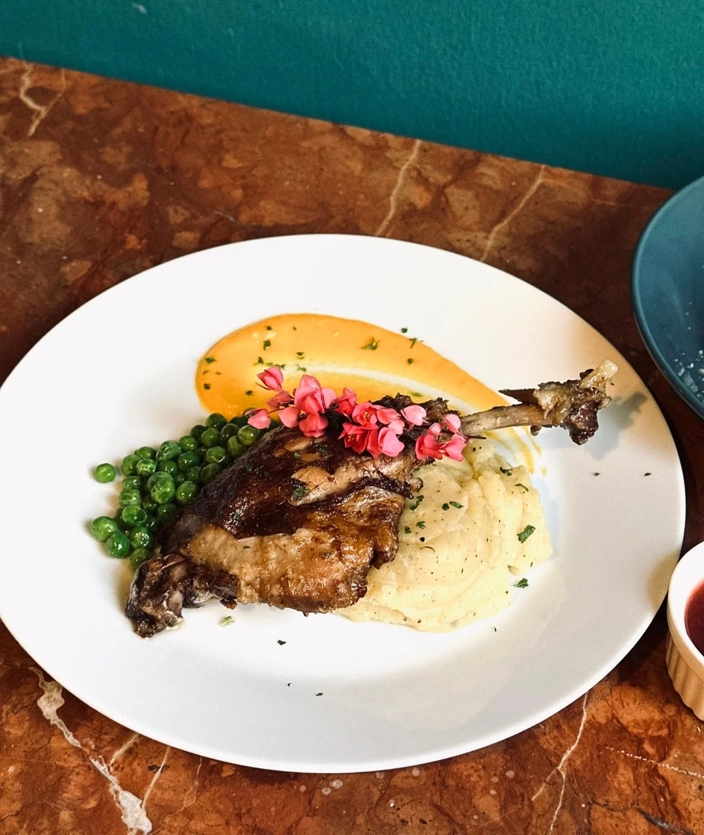 Introducing our new Duck Confit - Crispy on the outside, fall-off-the-bone tender inside &mdash; served with creamy mashed potatoes, saut&eacute;ed peas, a pomme pur&eacute;e, and a flourish of garnish. 💫

Come discover this beauty alongside our lat