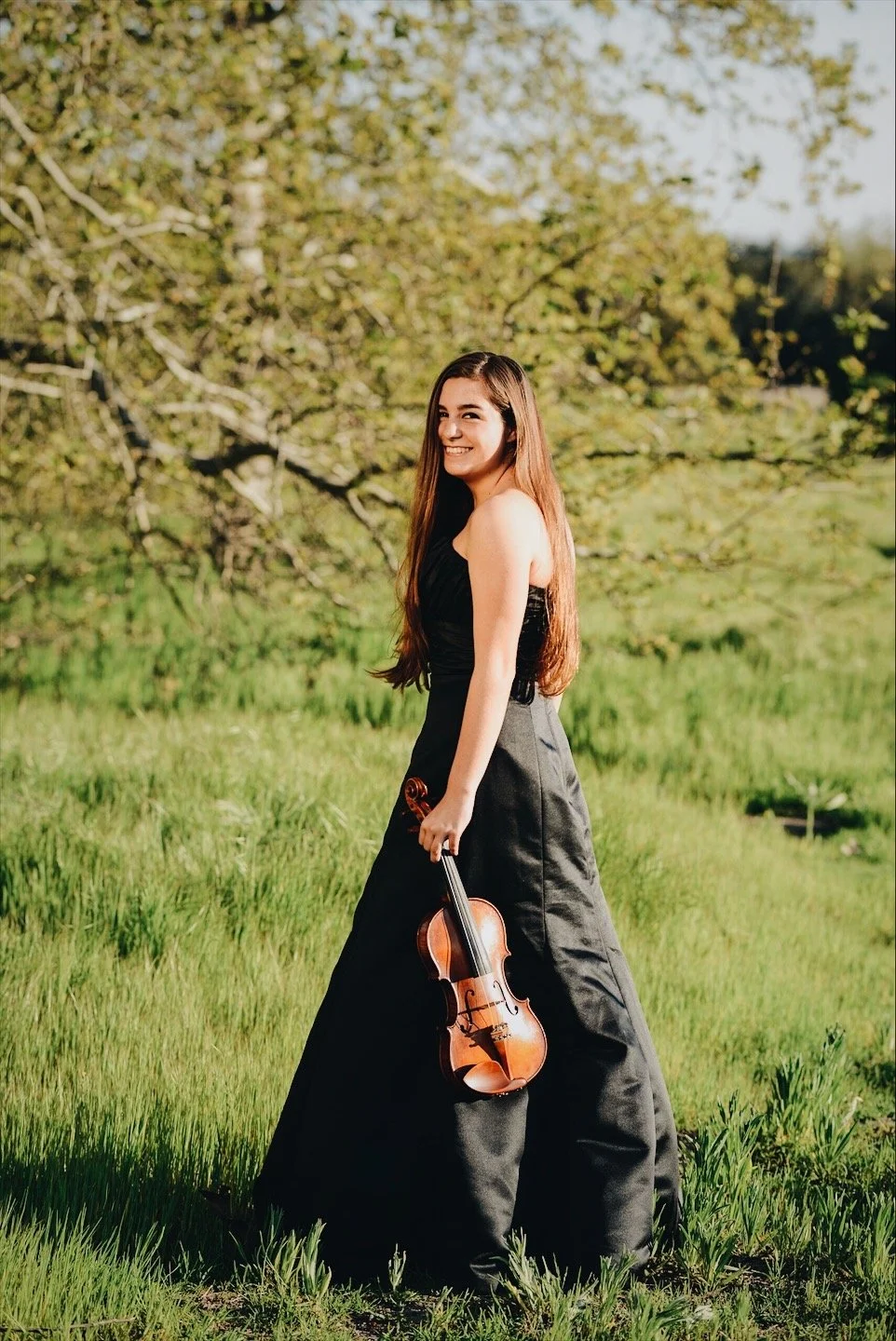Beautiful Becca in grassy field holding her Violin 