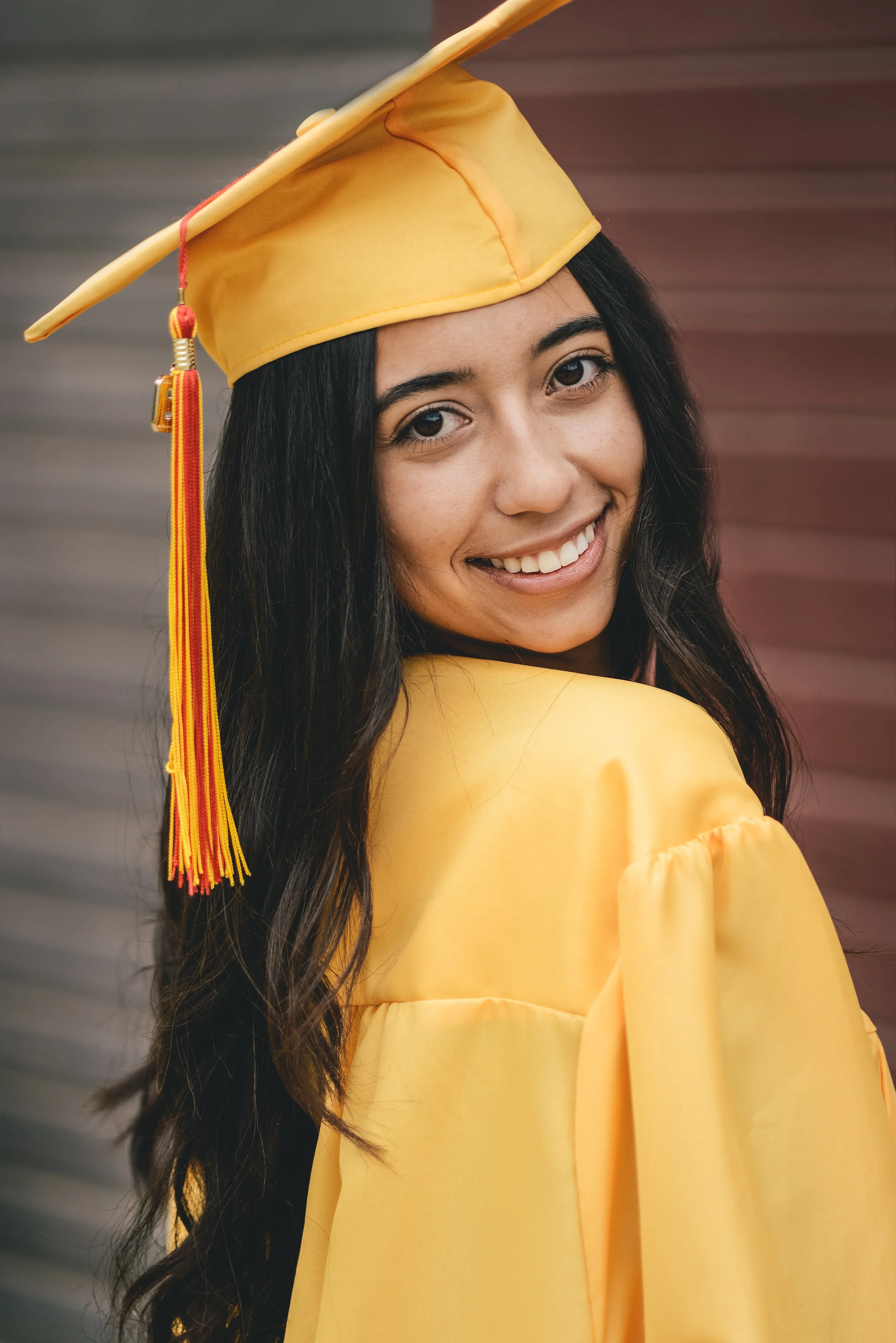 Beautiful High school graduation portrait of Marie in Gold cap and gown 