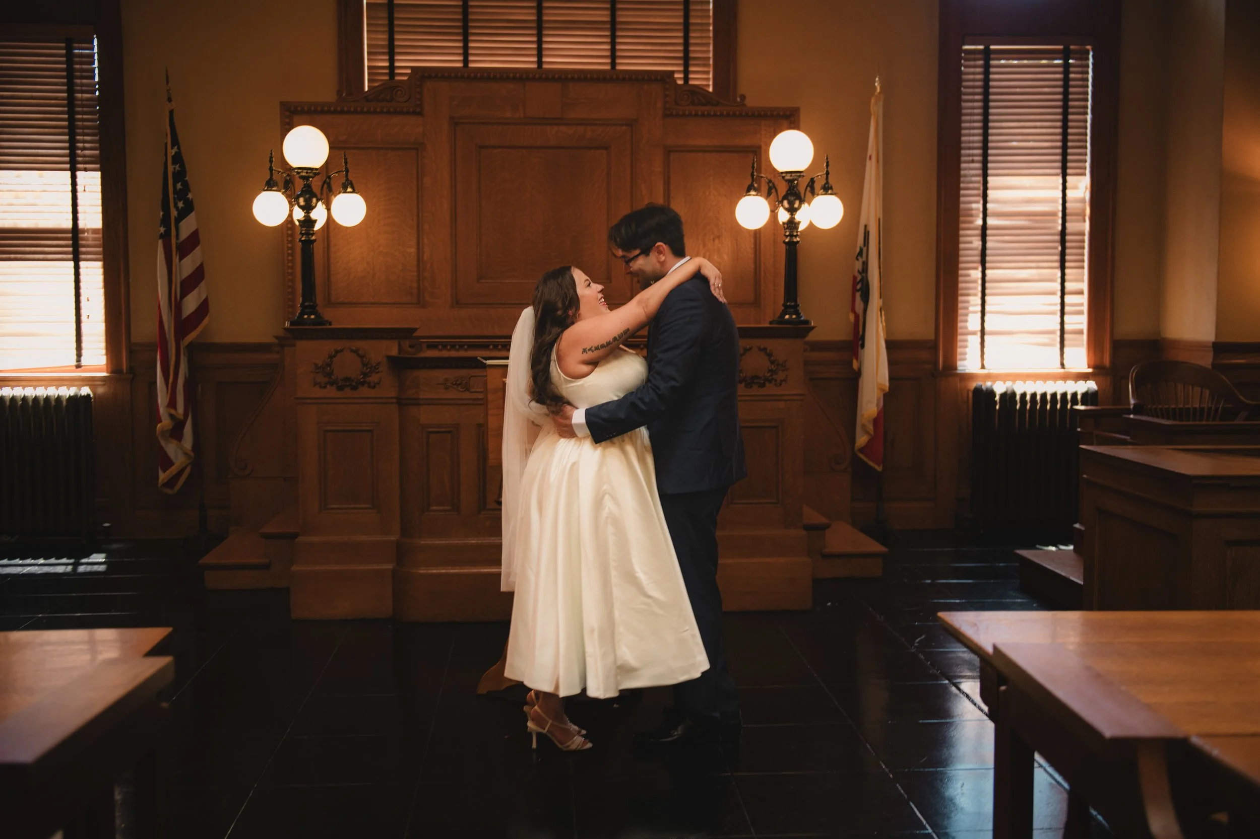 A bride and groom dancing in a moody room in Santa Ana, California during their wedding by Charlie ogden