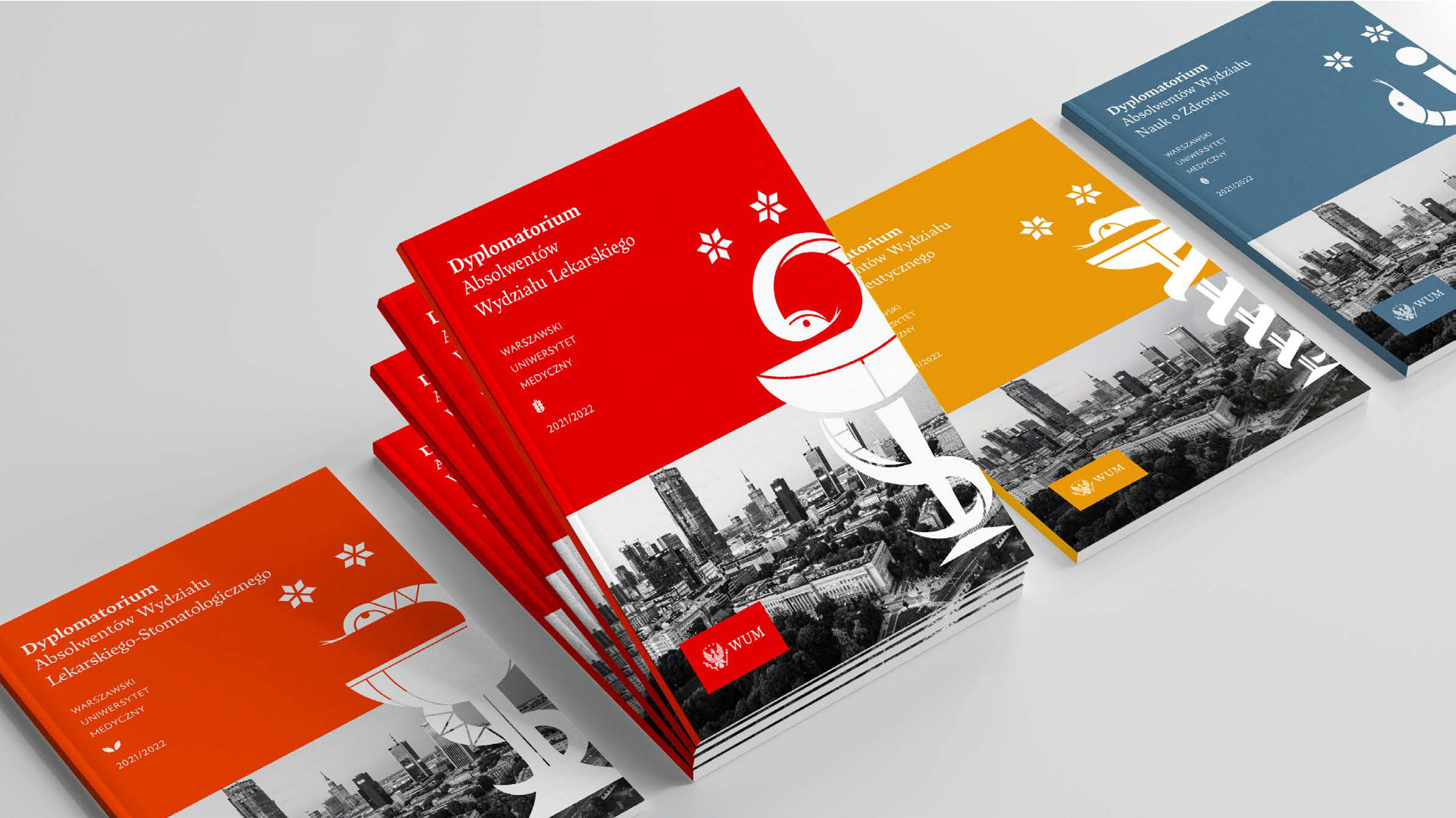 Set of academic diplomas for graduates of the Faculty of Medicine, in red, orange, and blue covers, featuring a cityscape skyline and medical symbols.