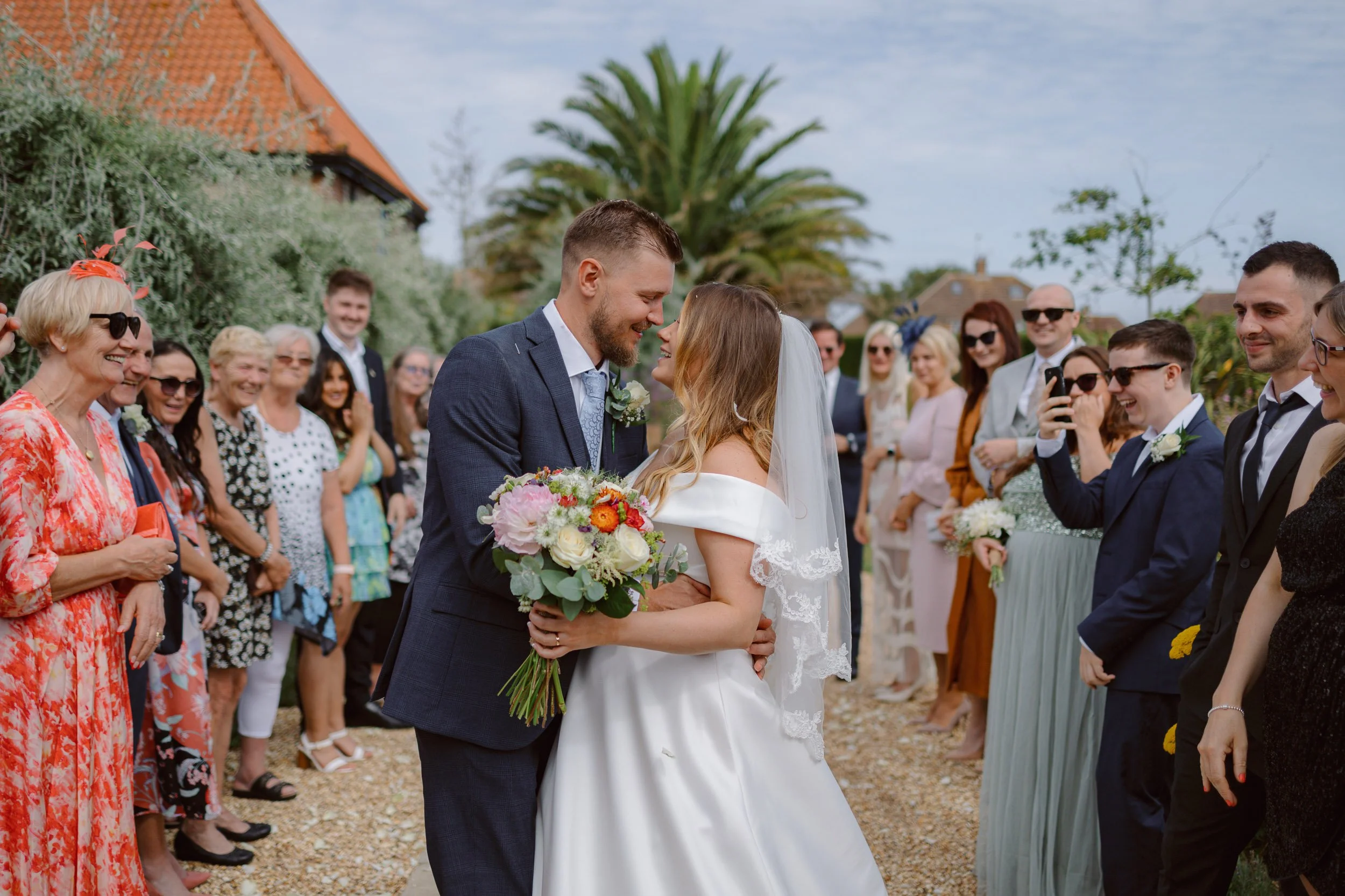 Couple going through a confetti tunnel at their wedding in Worthing