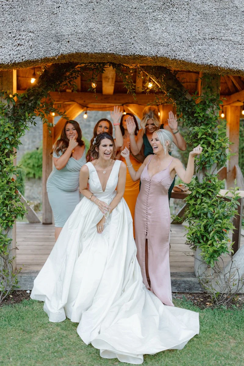 Bride and her friends laughing at the wedding reception at Westerhanger castle