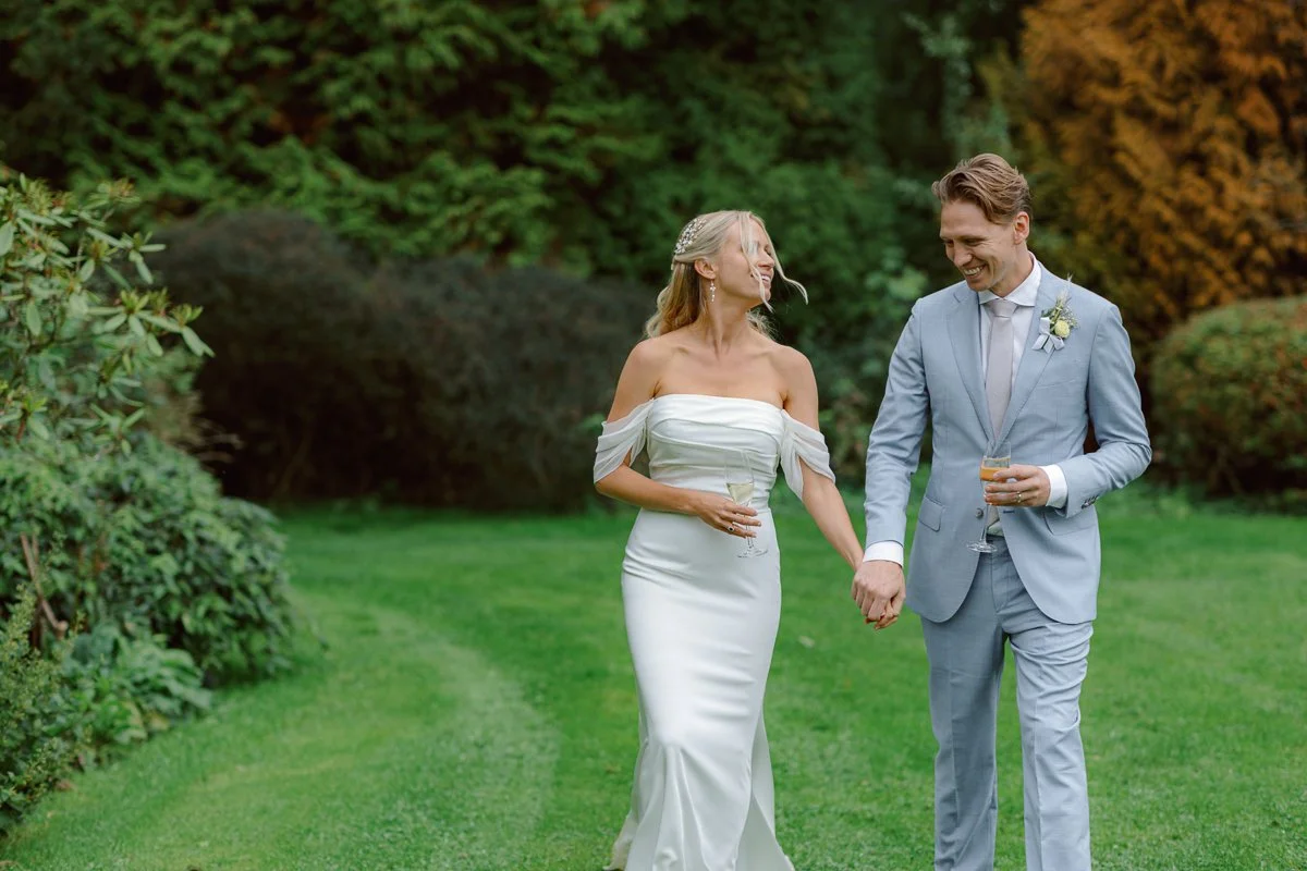 Bride and groom walking holding hands after the ceremony at Ridge farm, Surrey