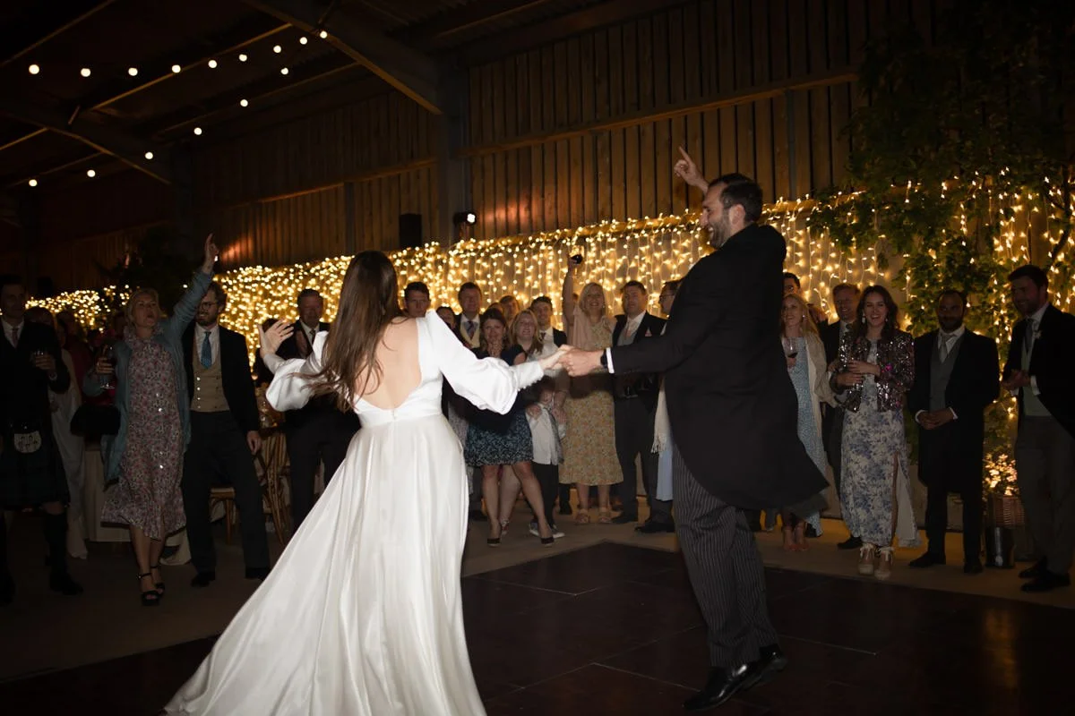 Couple having their first dance at a farm wedding