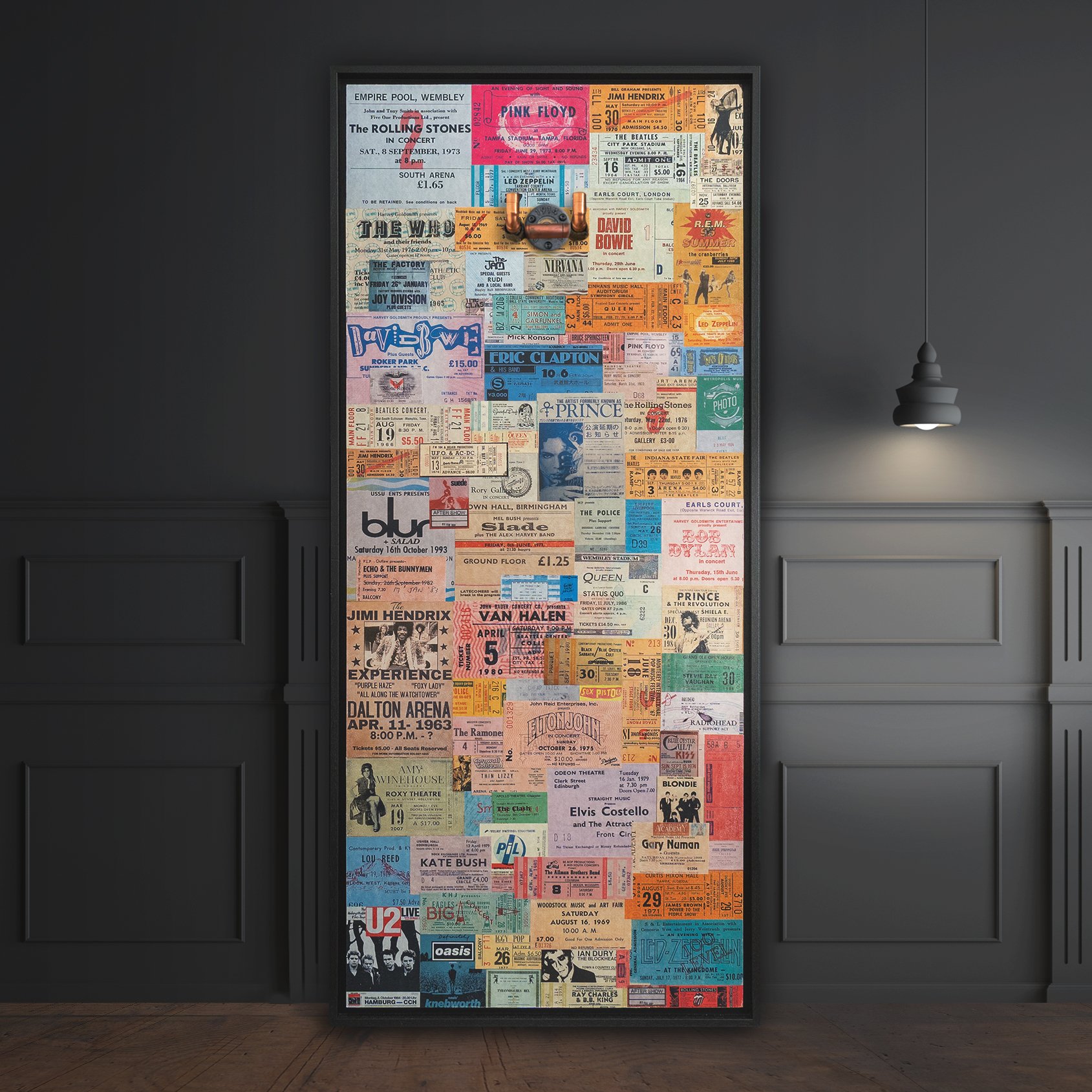Brass guitar hanger in a frame featuring iconic concert tickets