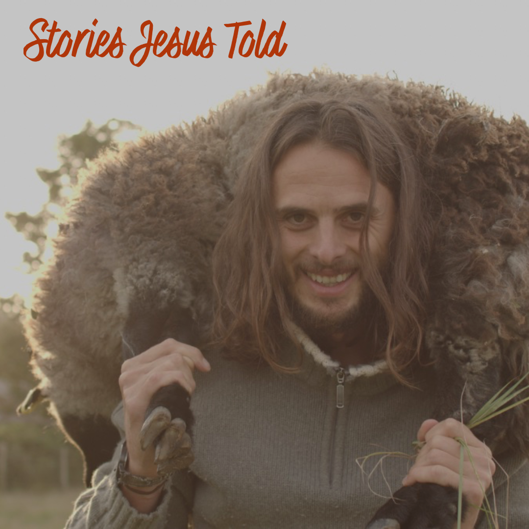 A smiling man carrying a large sheep on his shoulders outdoors at sunset.