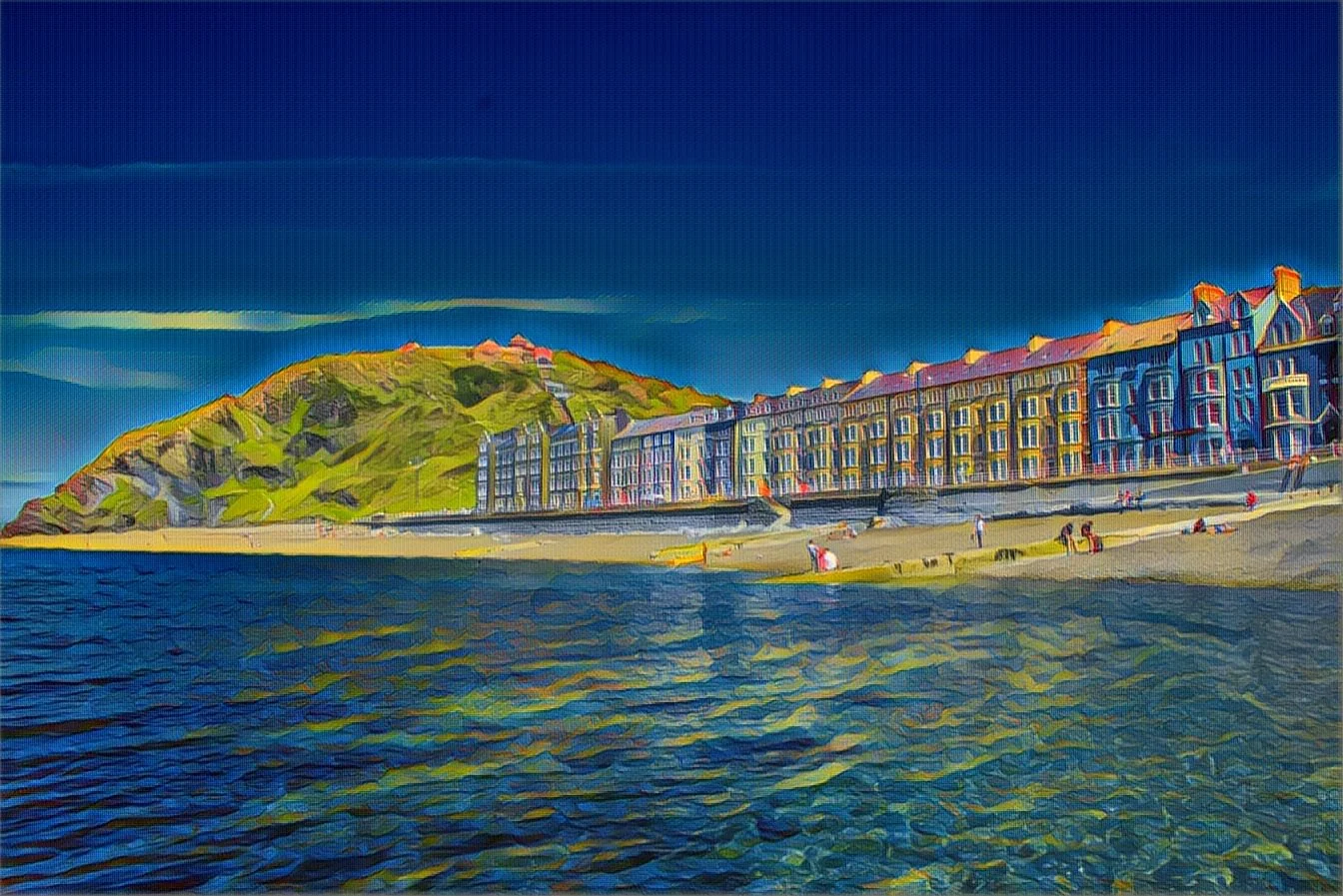 A colorful digital painting of a coastal scene with a hill on the left, purple matte buildings along the shoreline, and people walking on the beach with water in the foreground and blue sky above. Photography by photographer based in Southam, Warwick