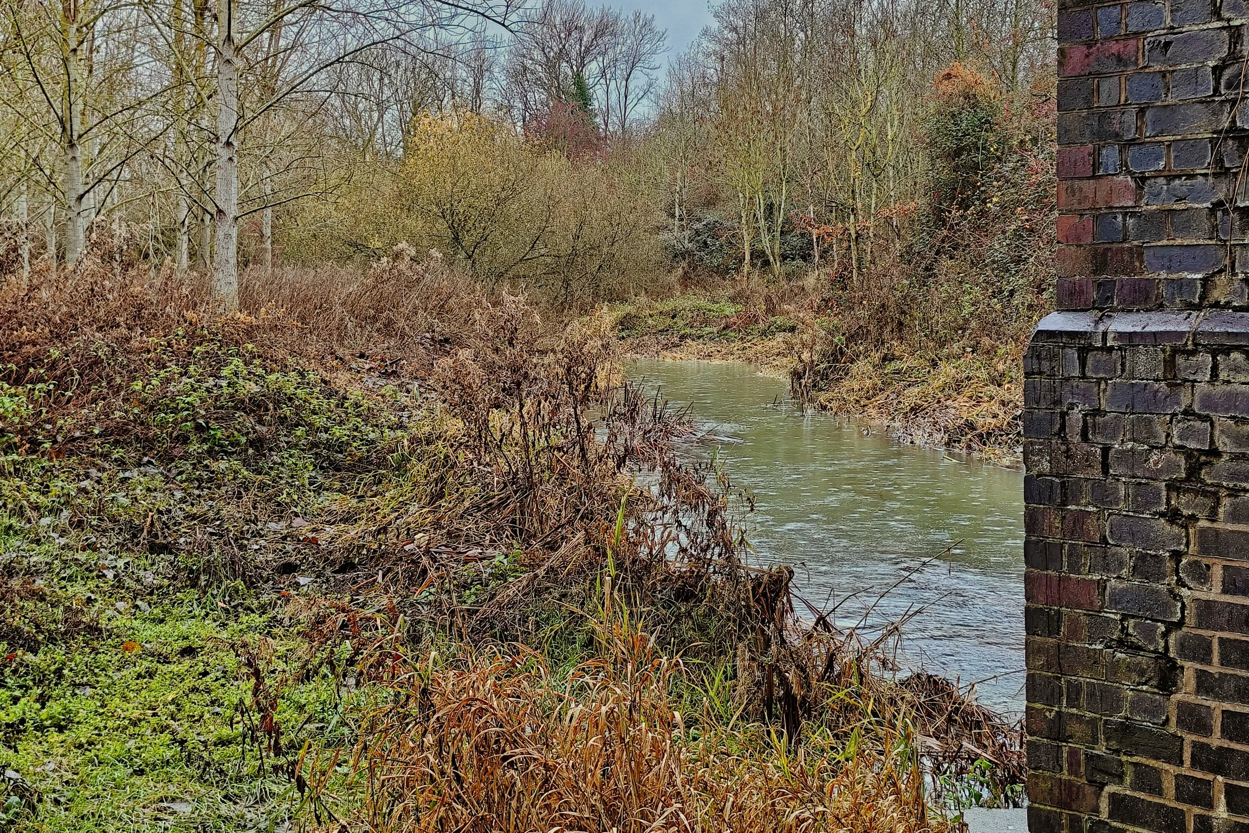 Rainy view of the River Itchen from the shelter of the old railway bridge near Long Itchington, Warwickshire