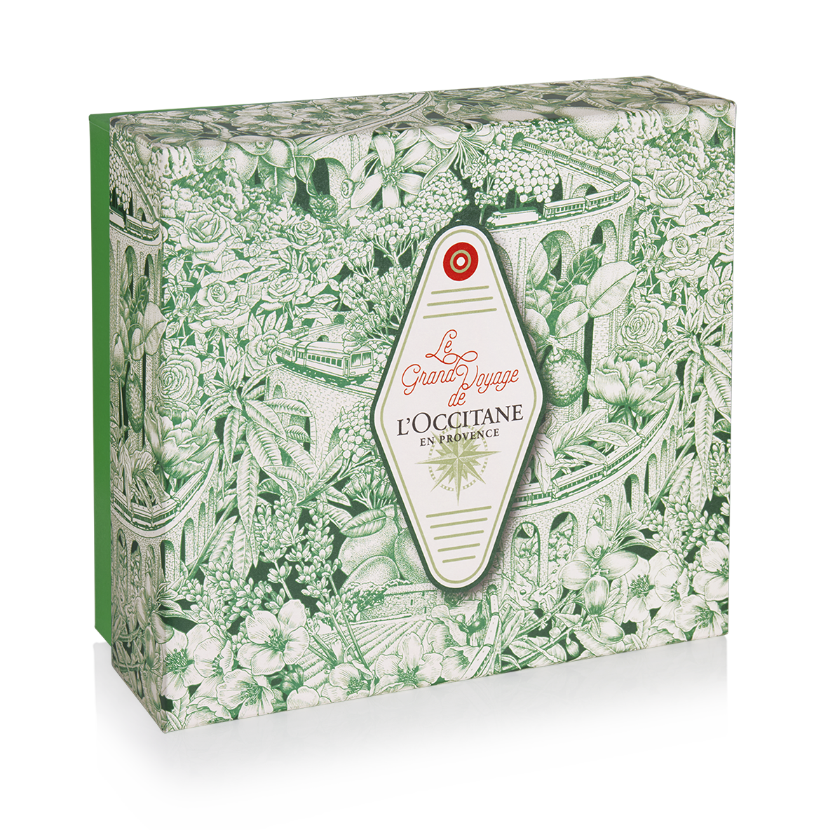 Boîte cadeau rectangulaire L'Occitane en Provence avec une illustration complète style Toile de Jouy en encre verte sur fond blanc, créée par l'artiste Shane Hello. Le visuel représente un paysage botanique dense (fleurs, agrumes, lavande) entrelacé 