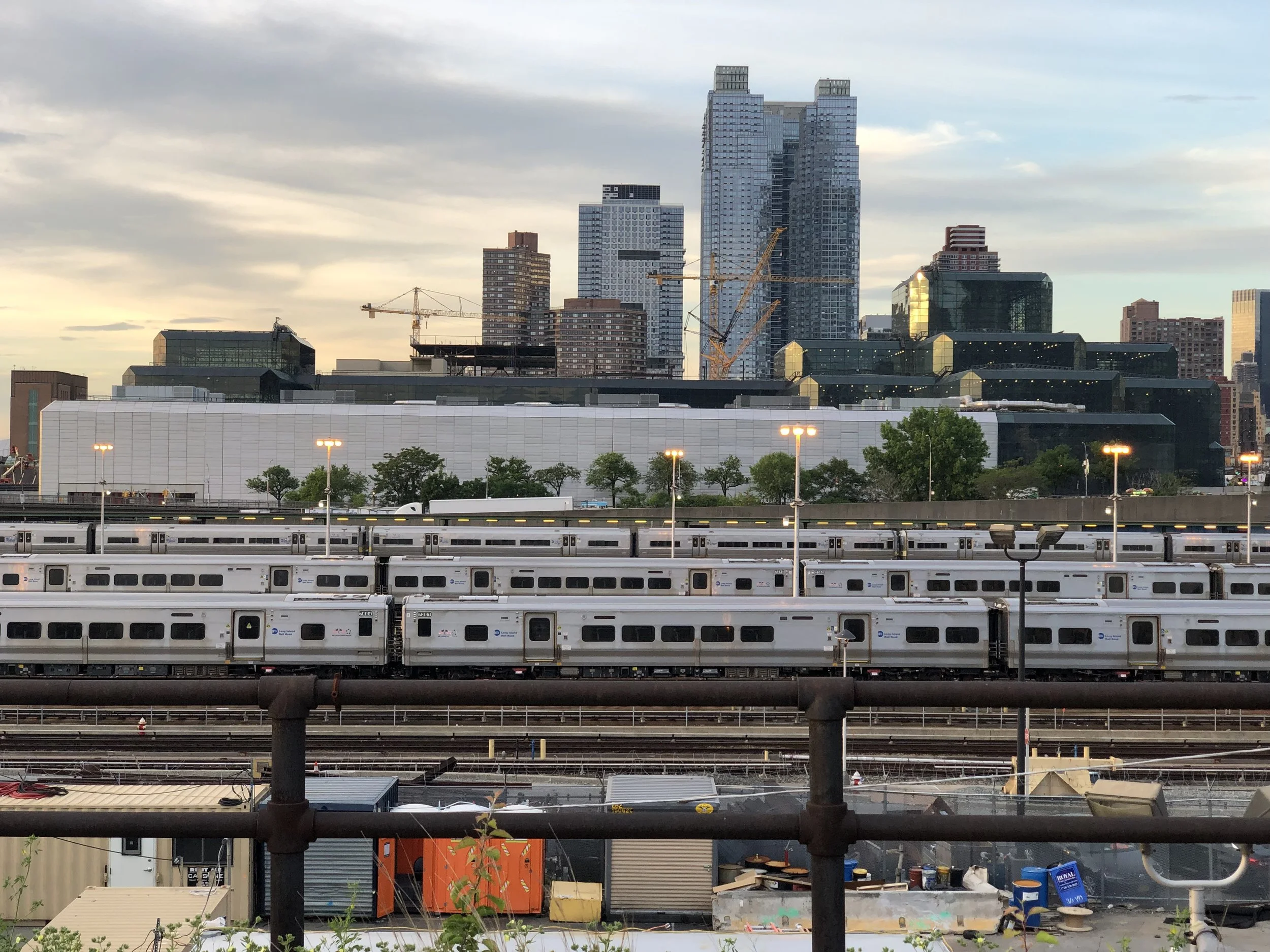 Long Island Rail Road trains in the yard against the Long Island City skyline