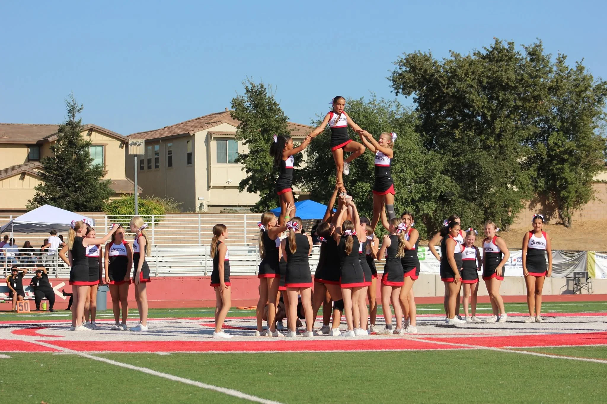 Cheerleaders holding pom poms above their head