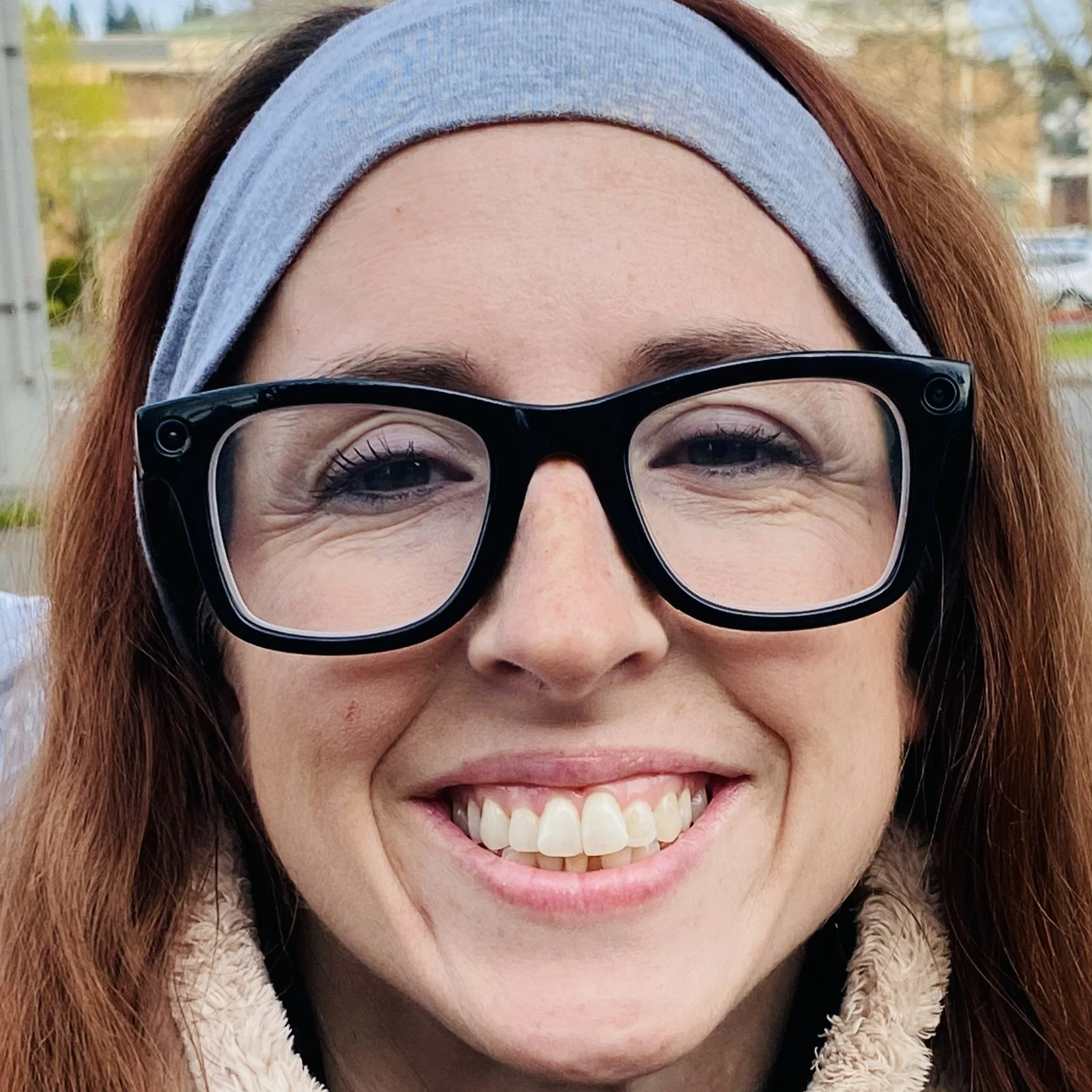 Photo of Jaime, a woman with brown hair who's wearing black glasses and a headband