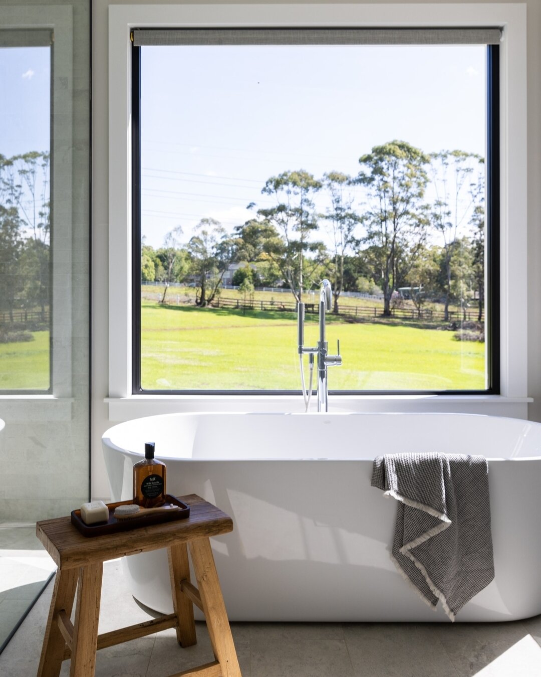 Is anyone else ready to put their feet up this weekend? It feels like the pace of life has accelerated this week.⁣
We wouldn't mind relaxing in this gorgeous tub with that incredible view. This is one of the bathrooms at our recently completed Dural 